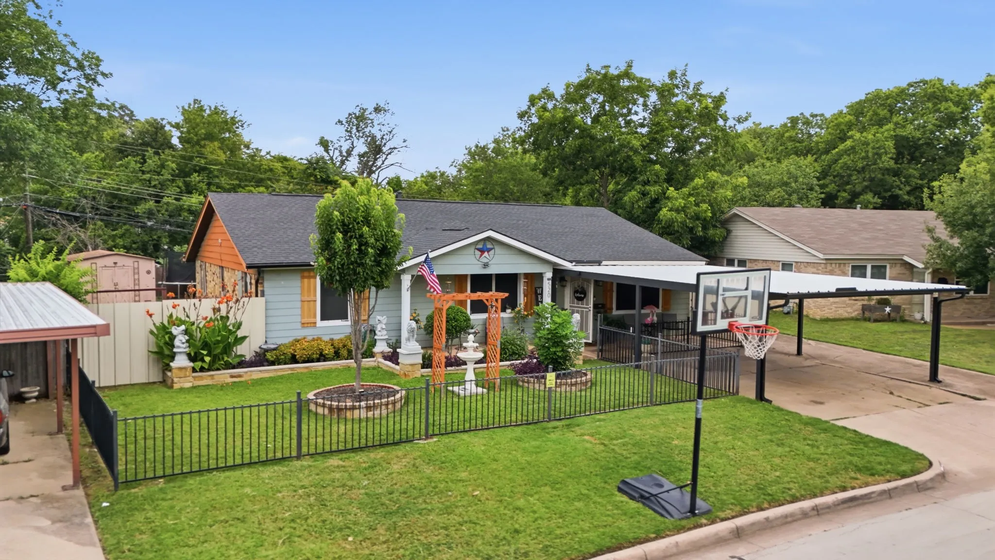 Ranch-style residence featuring a pale blue exterior with natural stone accents and a covered front porch