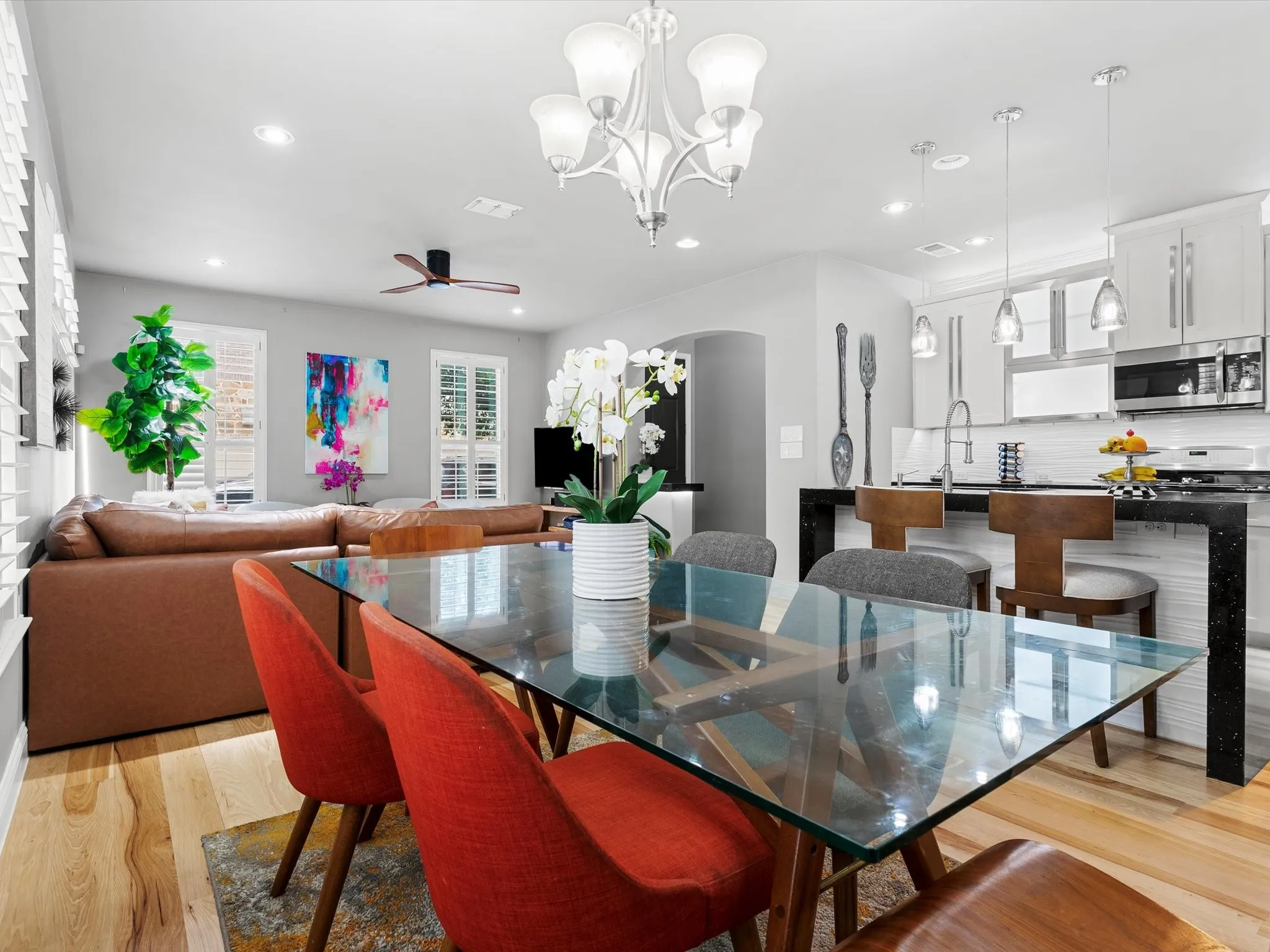 Open-concept living space featuring wood-finish flooring, recessed lighting, and a contemporary ceiling fan