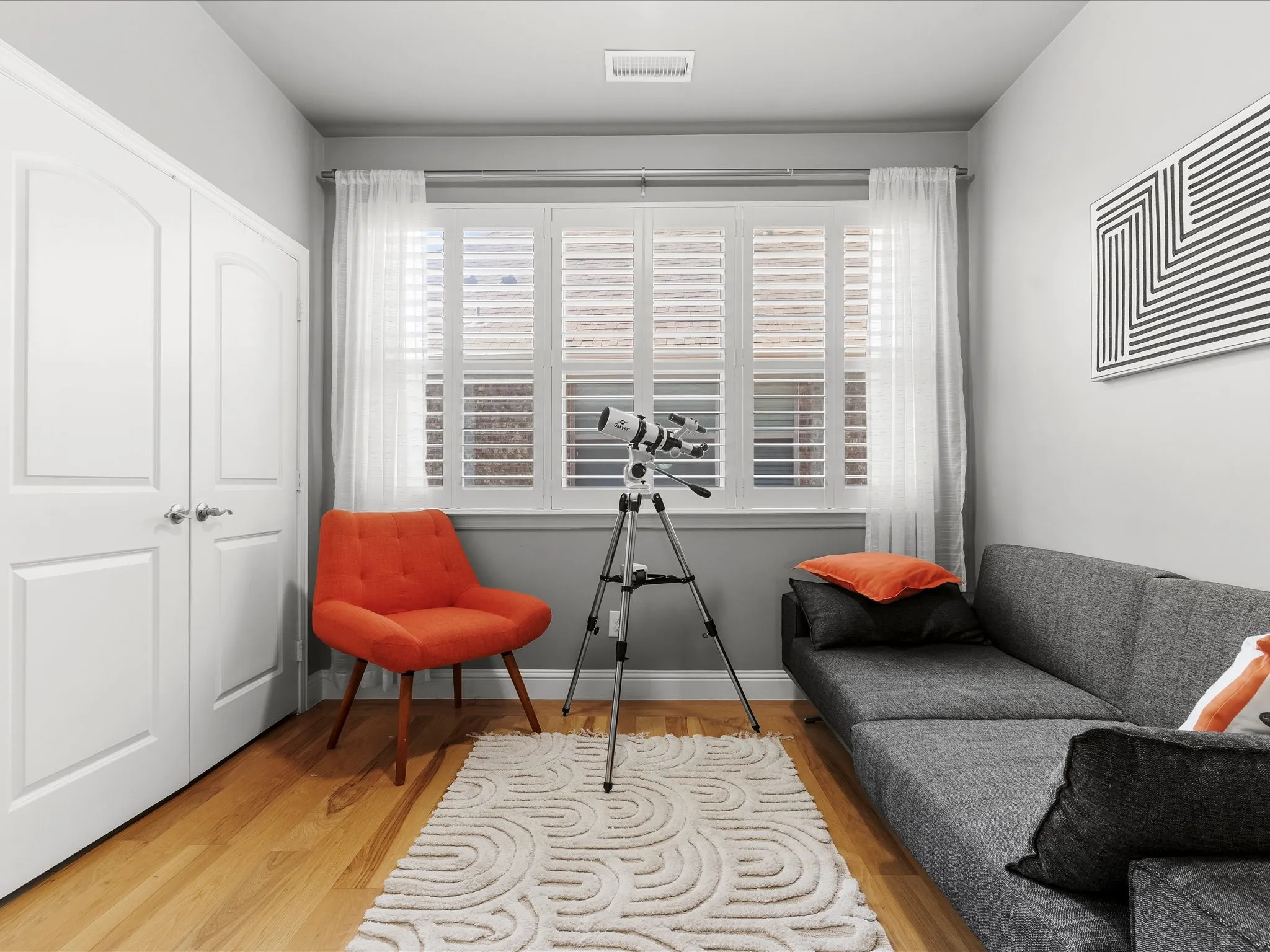 Hardwood-style flooring complementing light gray walls