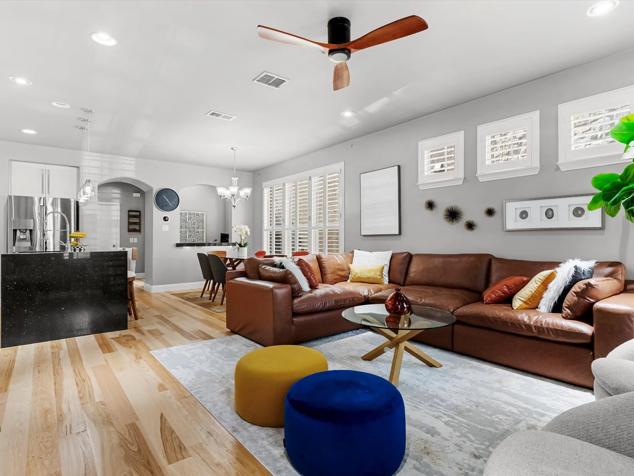 Open-concept living space featuring wood-finish flooring, recessed lighting, and a modern ceiling fan