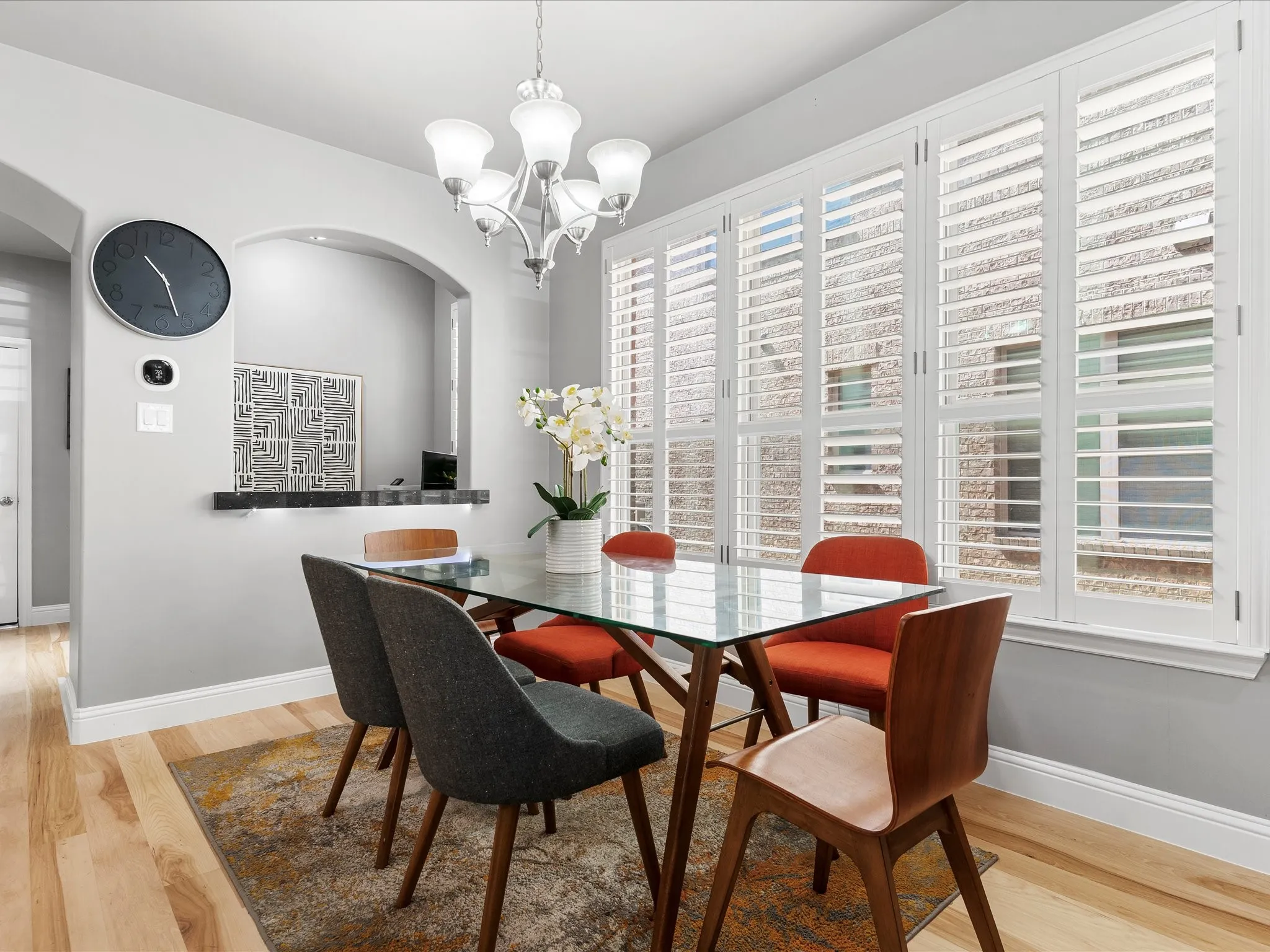 Dining area featuring light wood-finish flooring and a contemporary chandelier
