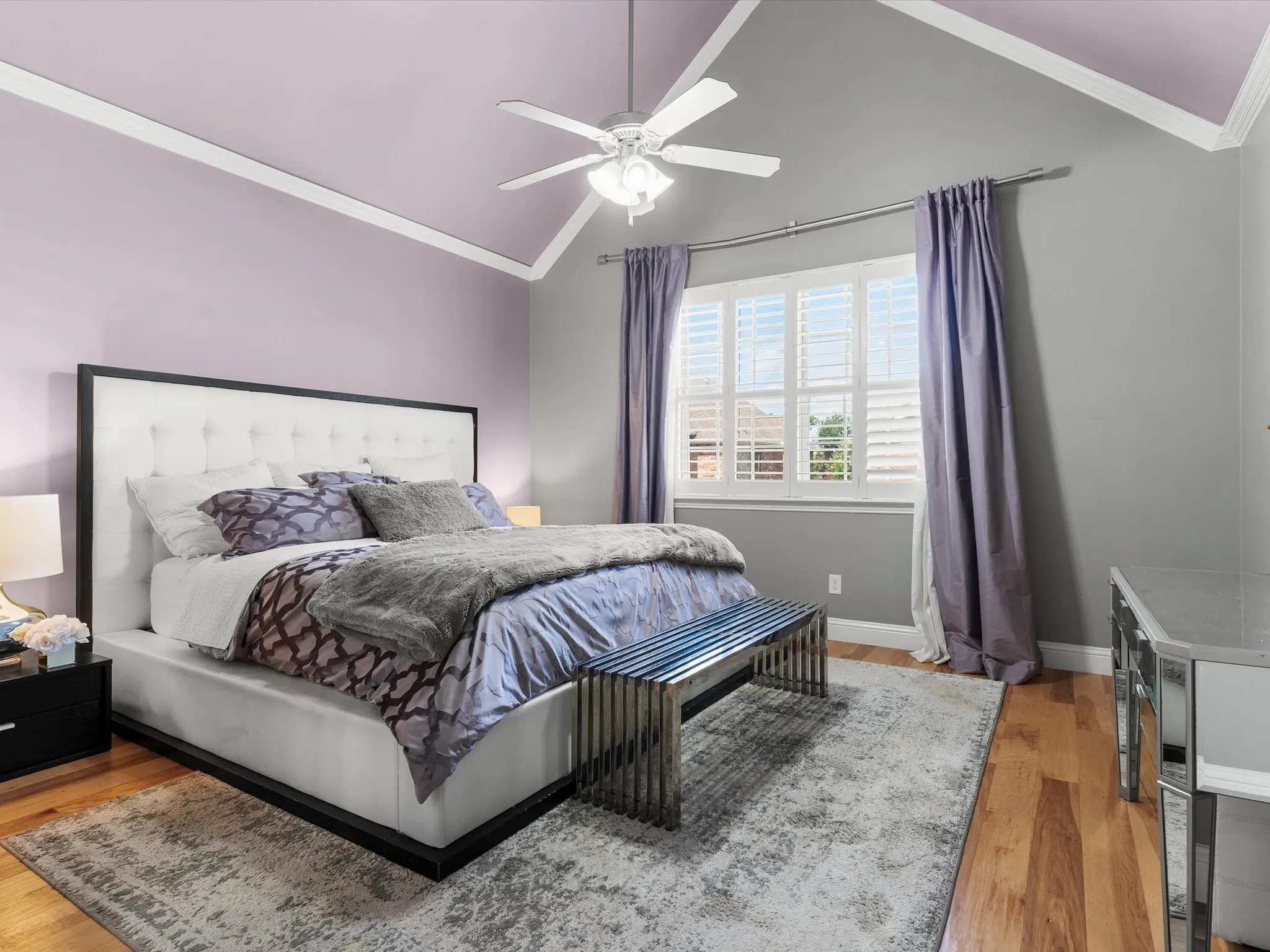 Bedroom featuring wood-finish flooring and a vaulted ceiling with a fan