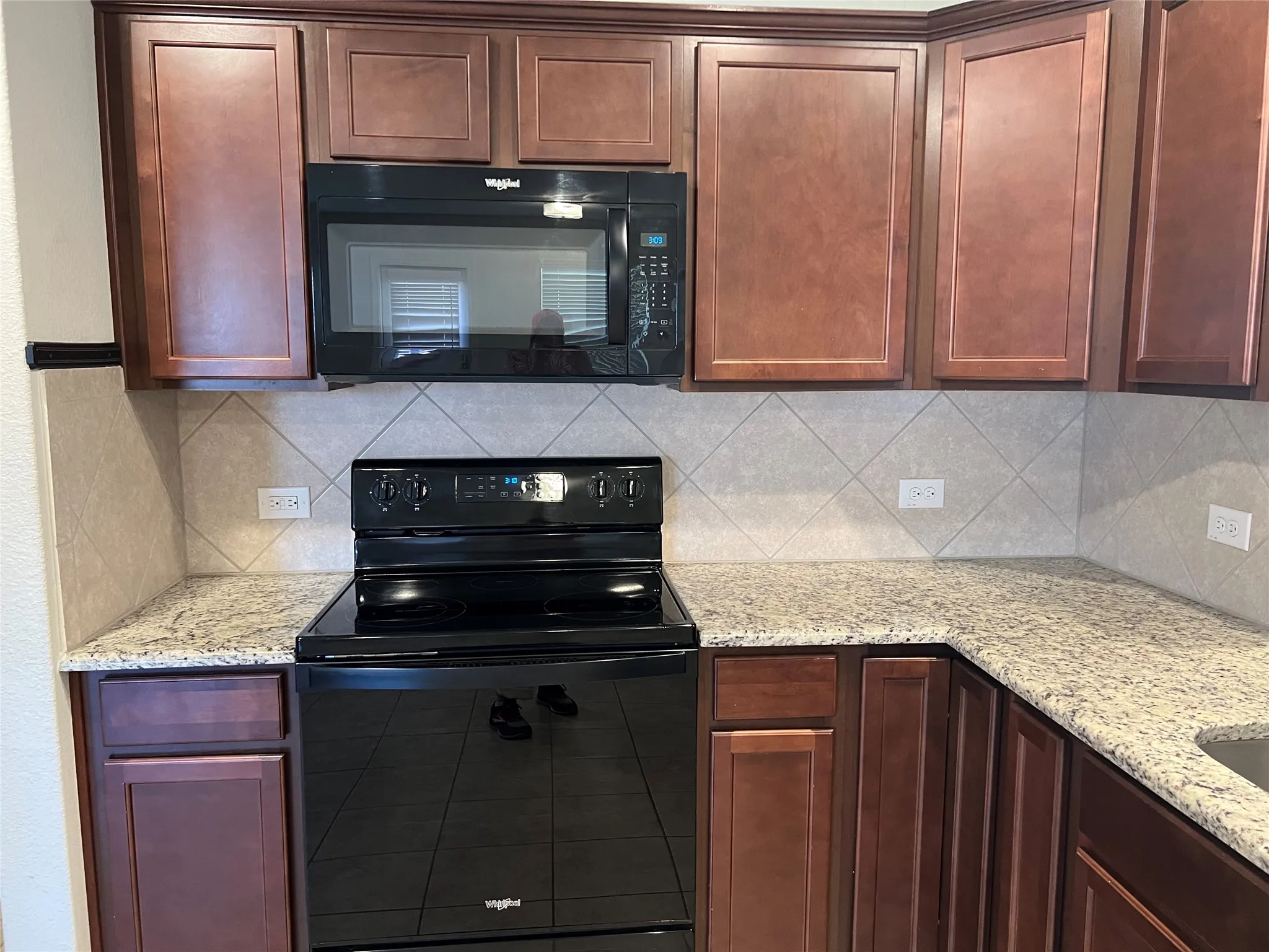 Microwave and smooth cooktop stove.