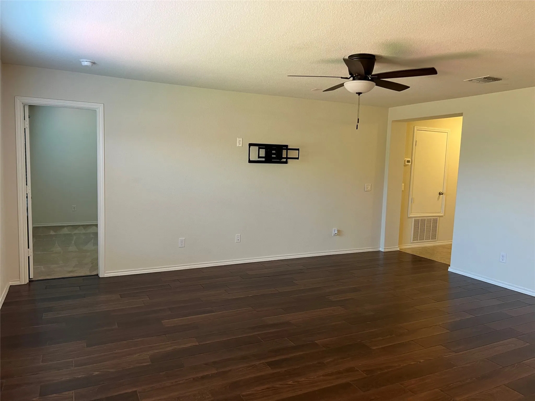 Hardwood floors. Primary bedroom to the left.