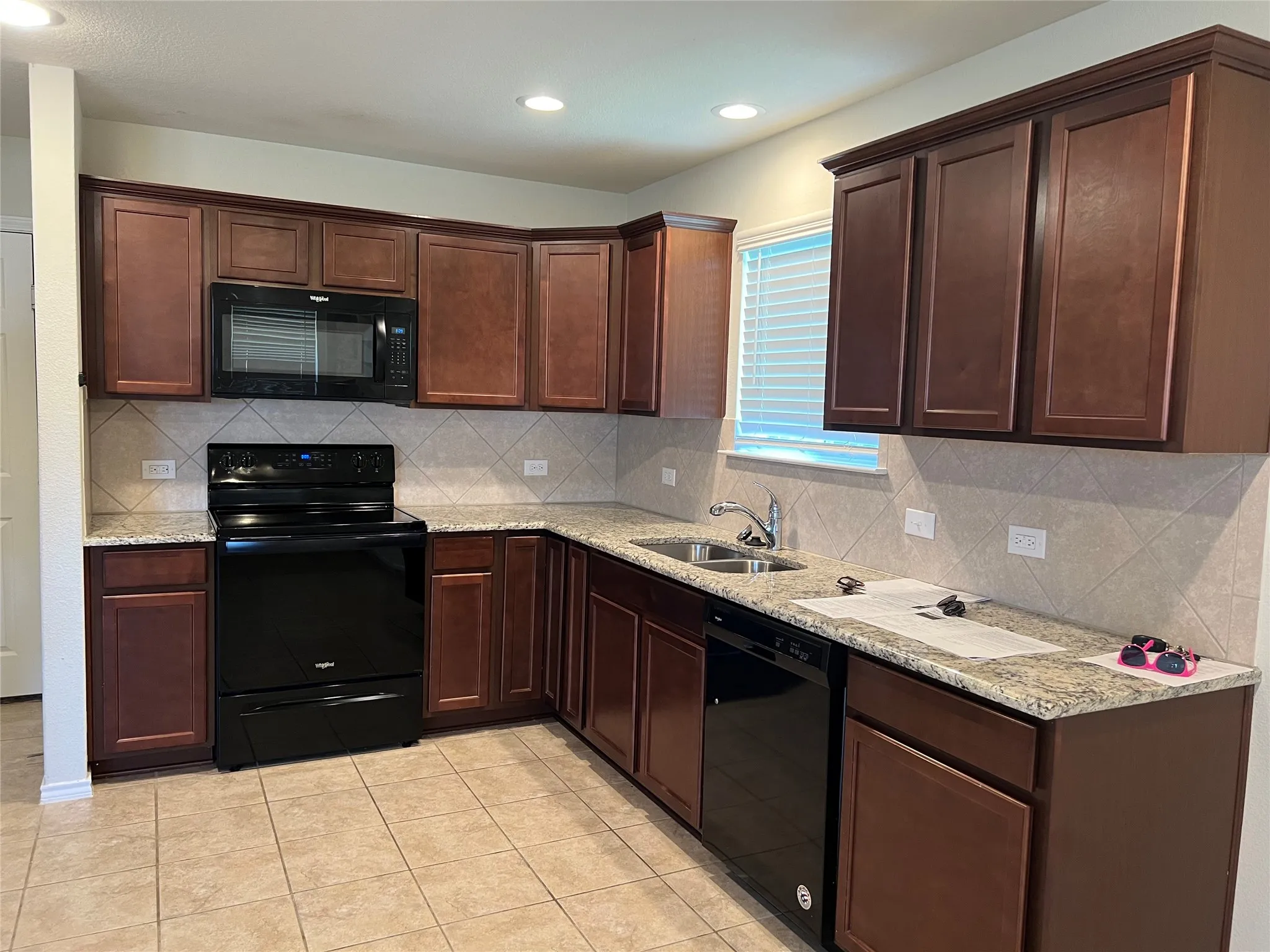 Granite countertops. Black appliances.