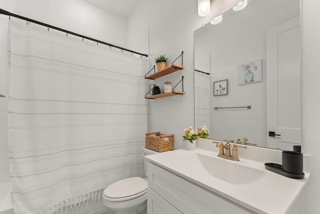 White bathroom vanity with an integrated sink and brushed nickel faucet