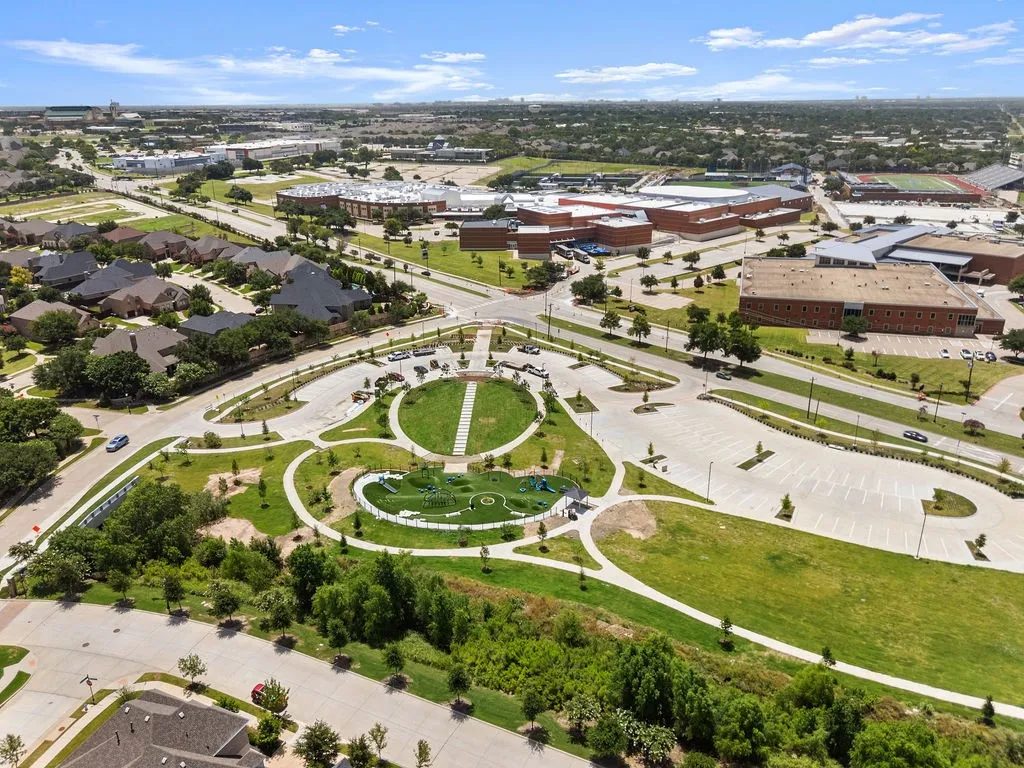 Aerial perspective showcasing a residential neighborhood with a central park area