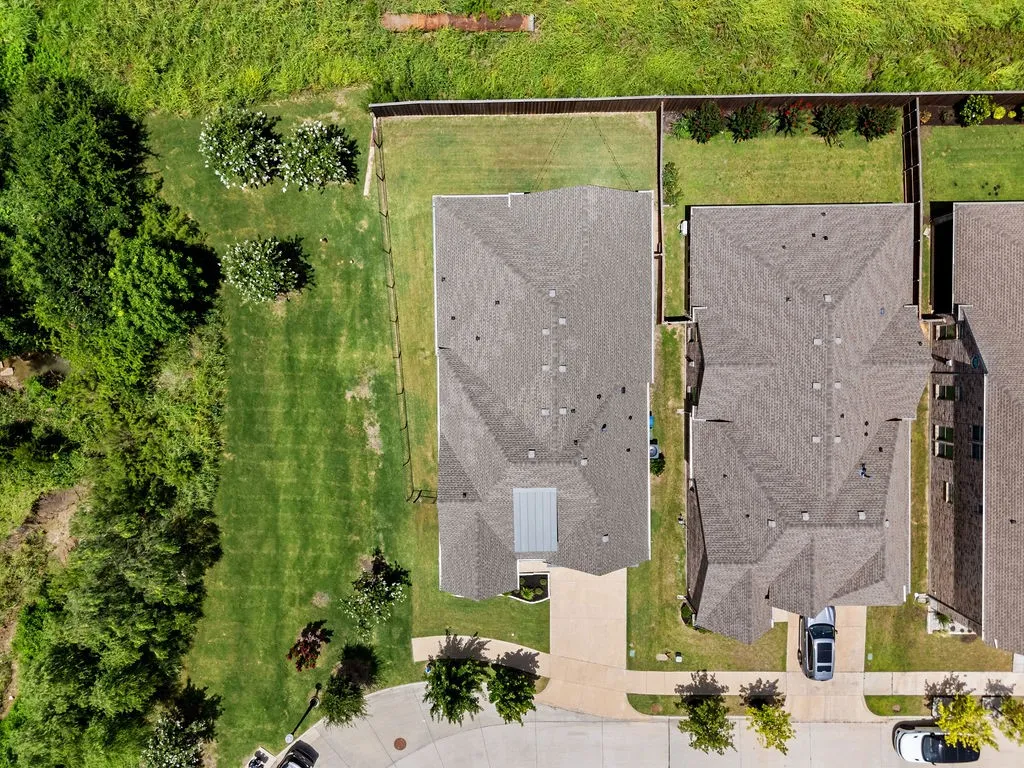Overhead view highlighting two residential properties with asphalt shingle roofing