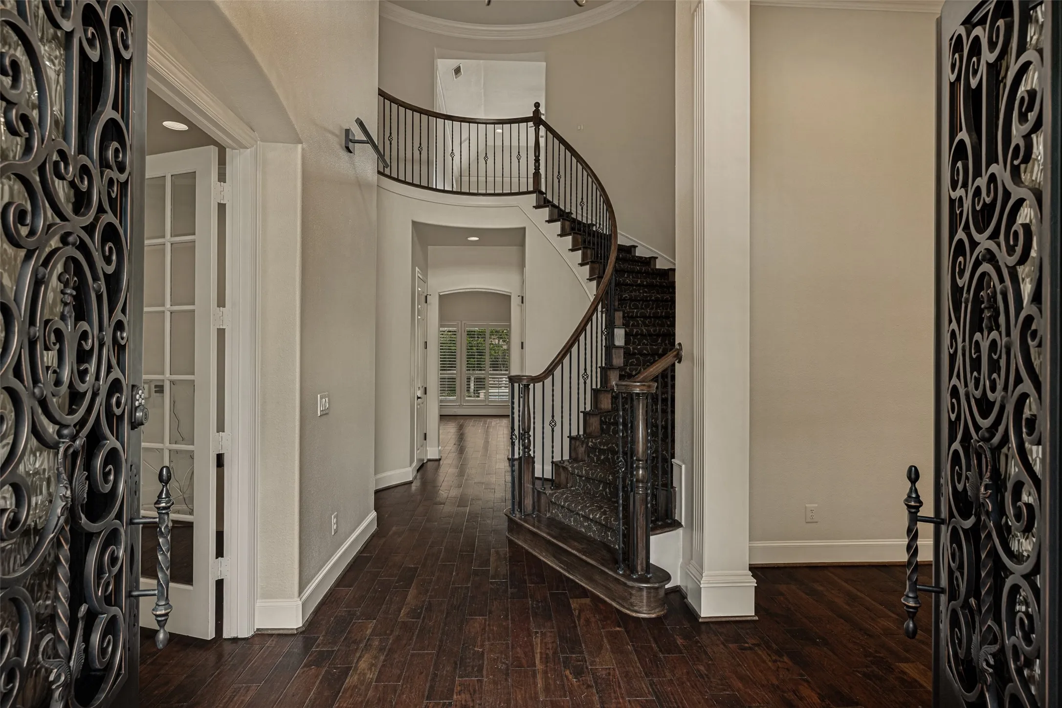 Welcome to this home!  When stepping inside, one can immediately see the special trademark features of a Huntington Home. Guests are greeted by the beautiful updated iron doors which open to this impressive foyer.  A rotunda design with a graceful curved staircase leads the eye upward.  Gleaming hardwood floors flow from the entry throughout most of the downstairs.  Crown molding is at the ceiling and a lovely chandelier and recessed lights illuminate the foyer.