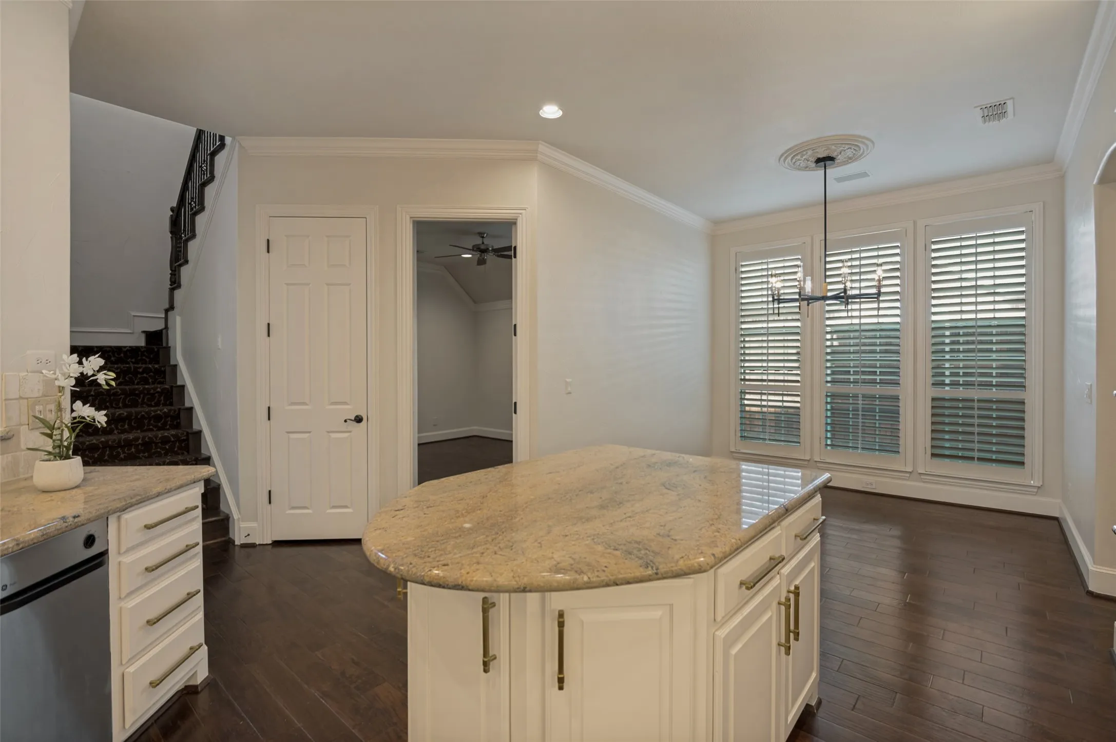 This central island in the kitchen will come in handy for food prep and serving.  Storage is maximized with cabinets and drawers in the island and the huge walk-in pantry just beyond.  Champagne gold hardware enhances cabinets and drawers.  The kitchen is filled with abundant light with numerous recessed lights and both under and above cabinet lighting.  A bonus room is also nearby.