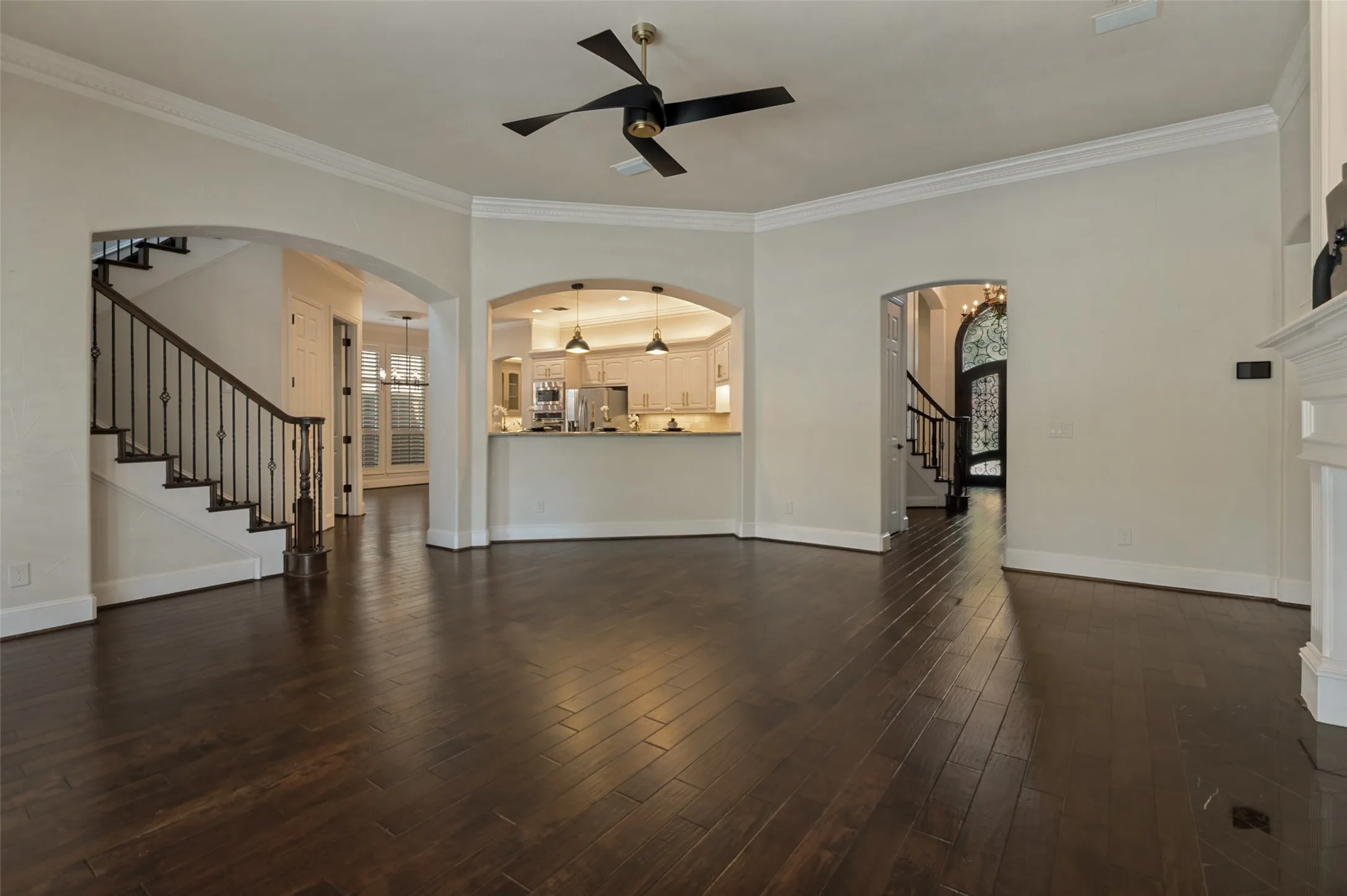 The kitchen opens to the family room with a handy breakfast bar.  Guests and family can pull up a stool for a quick snack or to join in the activities in the kitchen.  A pair of pendant lights shine above the breakfast bar.  The hallway from the entry includes a large storage closet.  Views from the front door all the way to the windows in the family room extend into the backyard creating instant architectural interest.