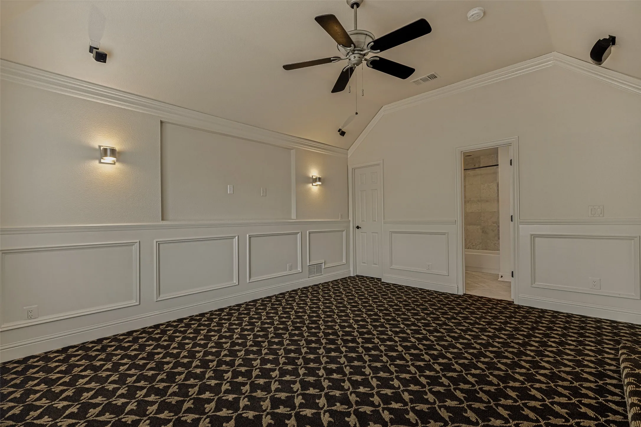 The slightly indented space on the wall is perfect for a large TV.  Decorative sconces on either side provide light.  A breezy ceiling fan keeps the room cool, and speakers remain available on the ceiling.  However, if a 4th bedroom is needed, the included closet and direct access to a full bath make it easy.  Add a big beanbag for a cozy reading niche or a desk for studies in the raised area and it becomes the perfect bedroom again.