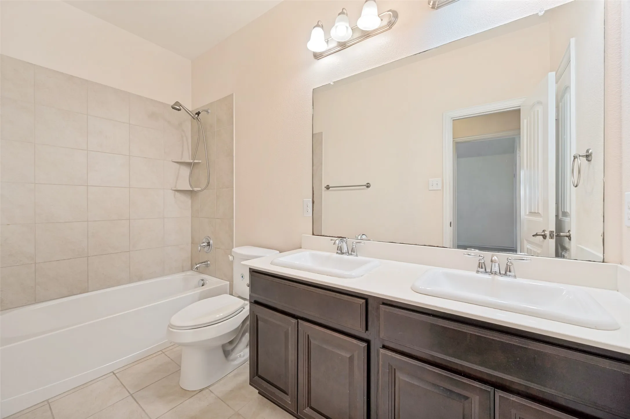 Second Bathroom featuring a double vanity with dark wood-finish cabinetry and white countertops