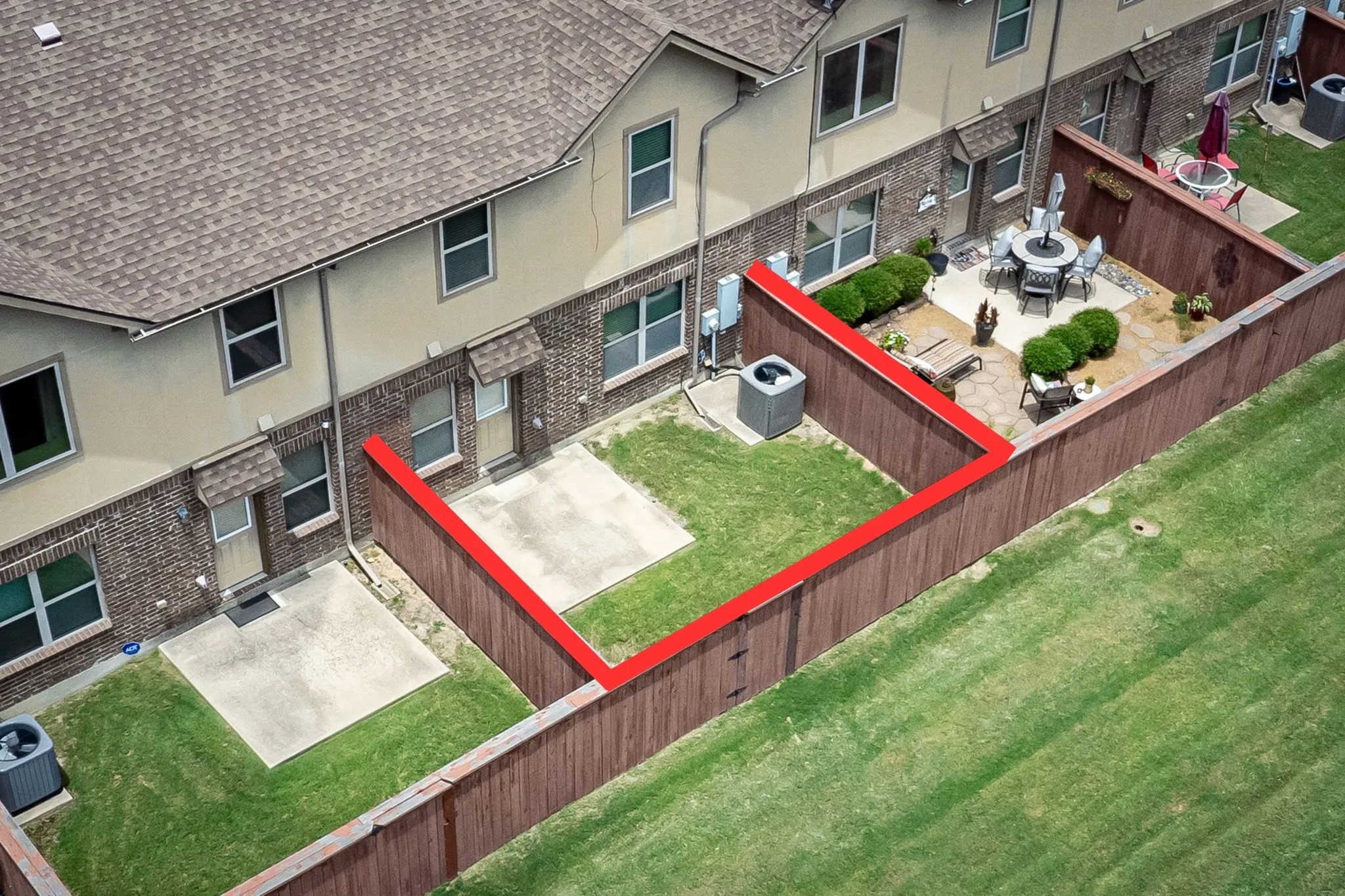 Aerial view with backyard boundary marked.