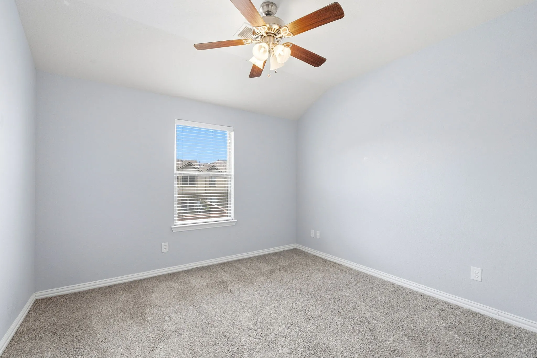 Secondary bedroom featuring carpet flooring and ample natural light.
