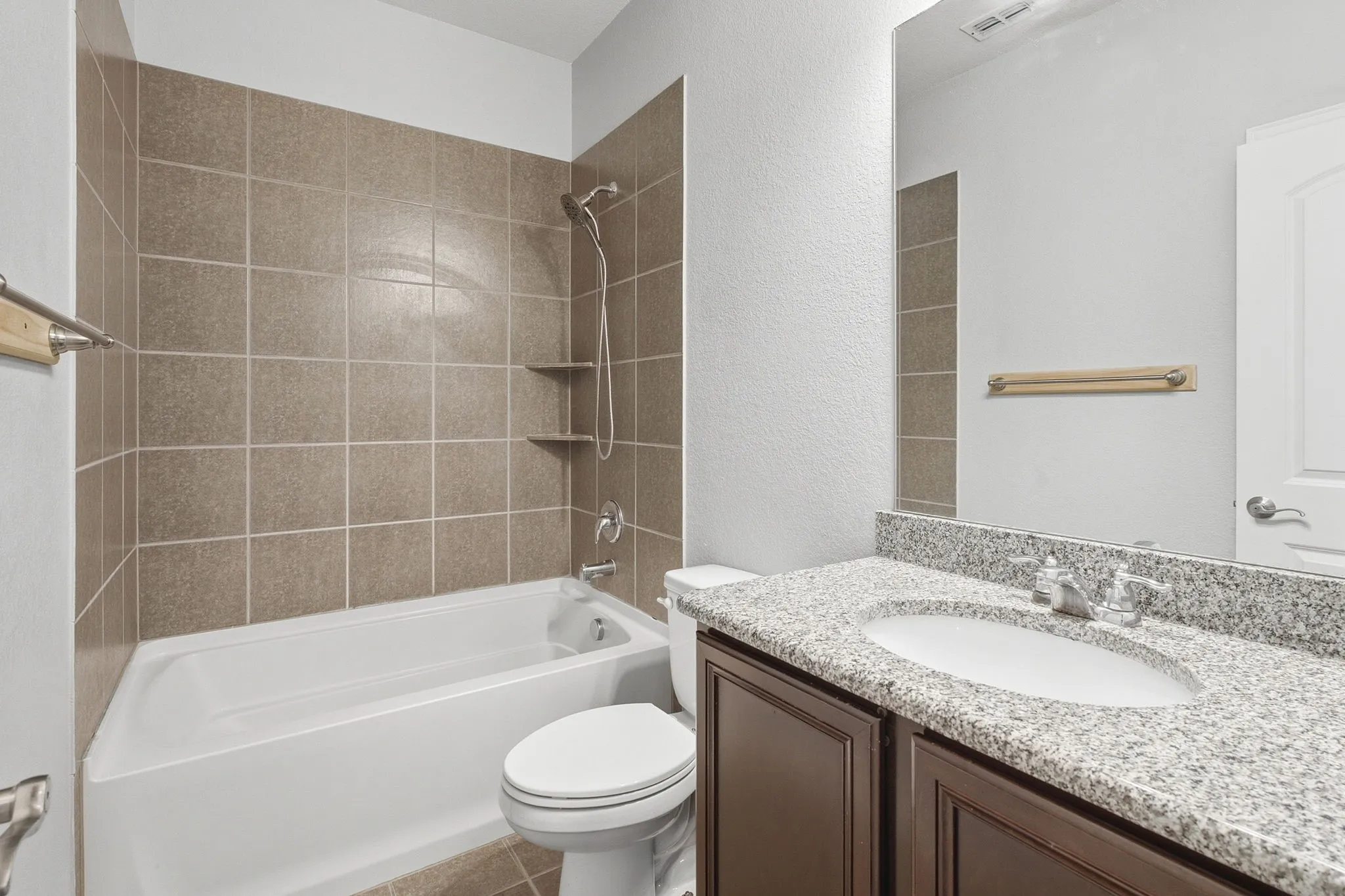 Upstairs full bathroom with vanity and tub-shower combination.