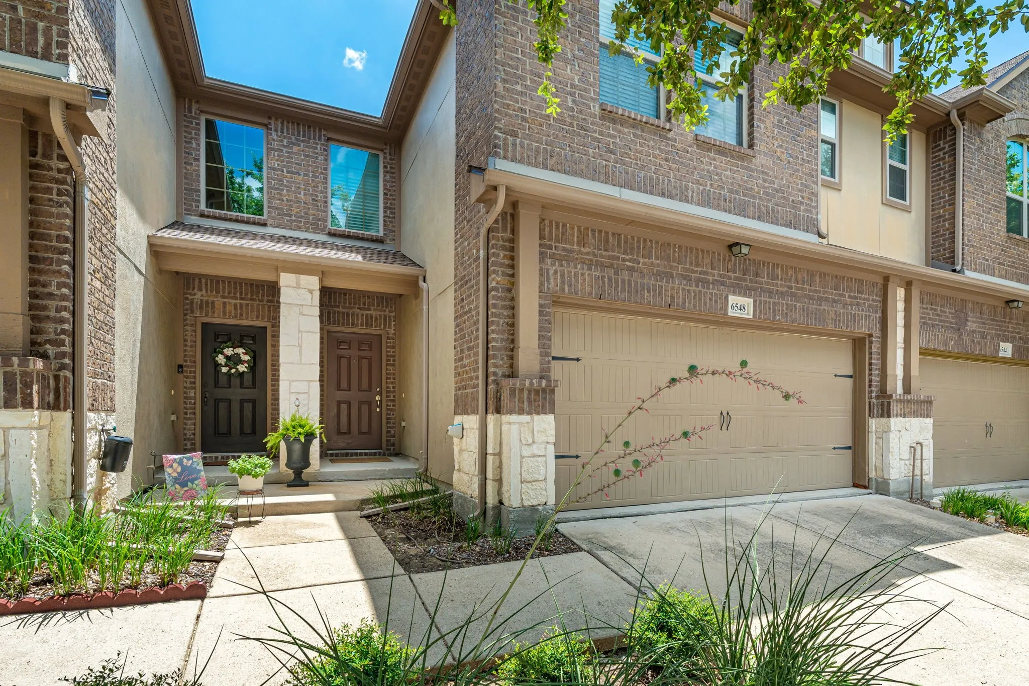Front exterior with HOA-maintained landscaping and a well-kept exterior