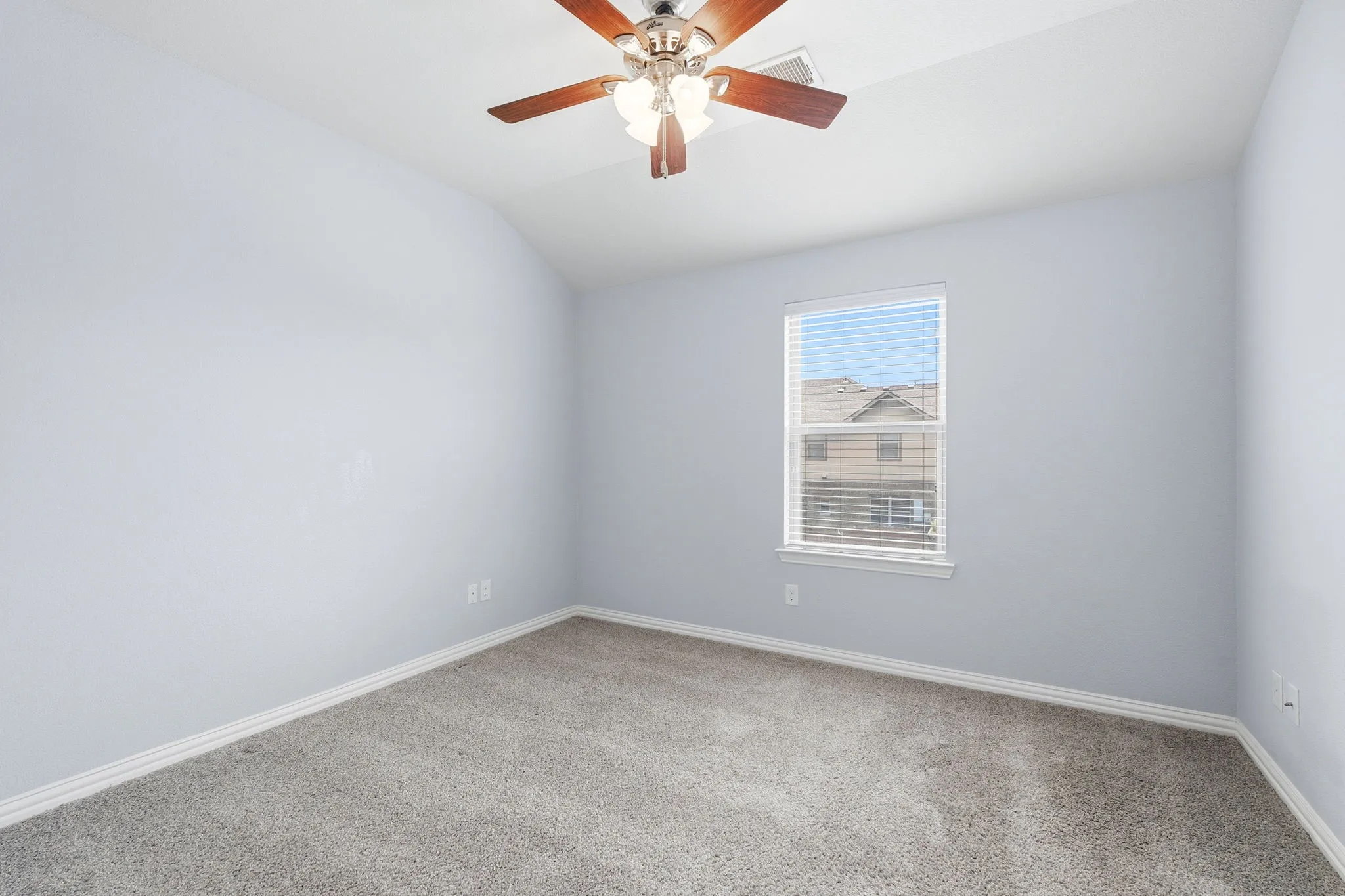 Another secondary bedroom featuring carpet flooring and ample natural light.