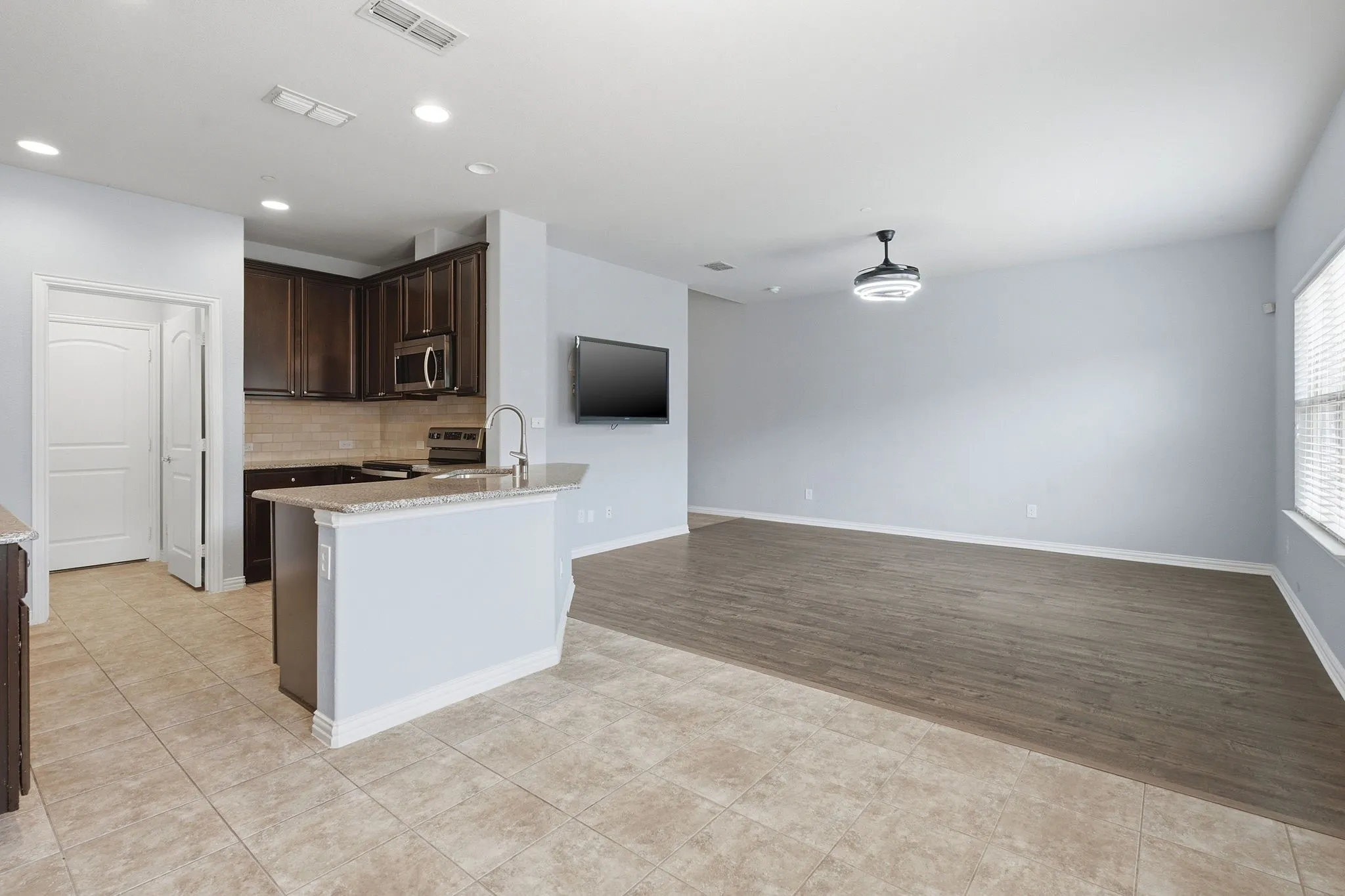 Living room and kitchen view from dining area.