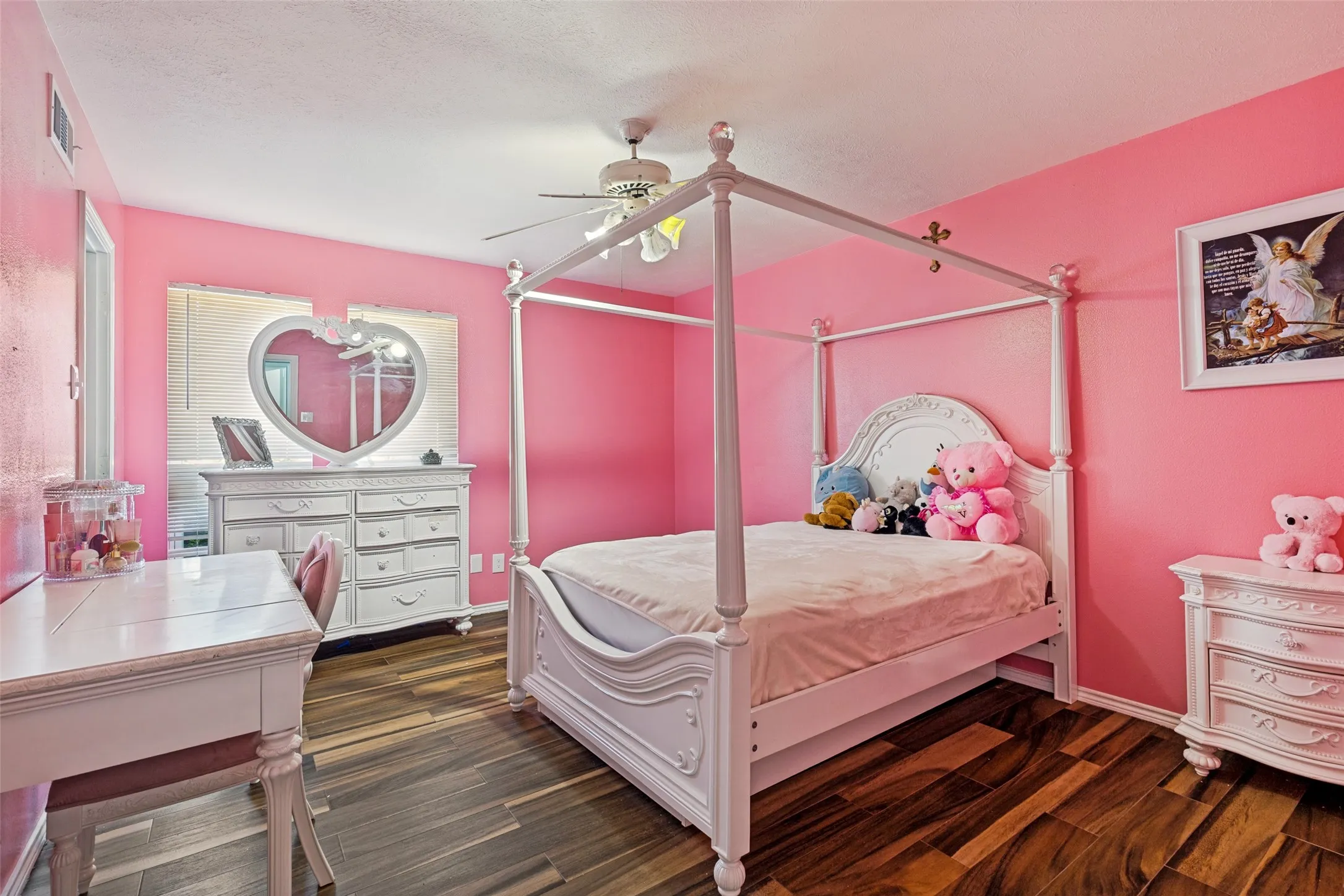 Bedroom featuring wood-finish flooring, a ceiling fan with light fixture, and a built-in window with horizontal blinds