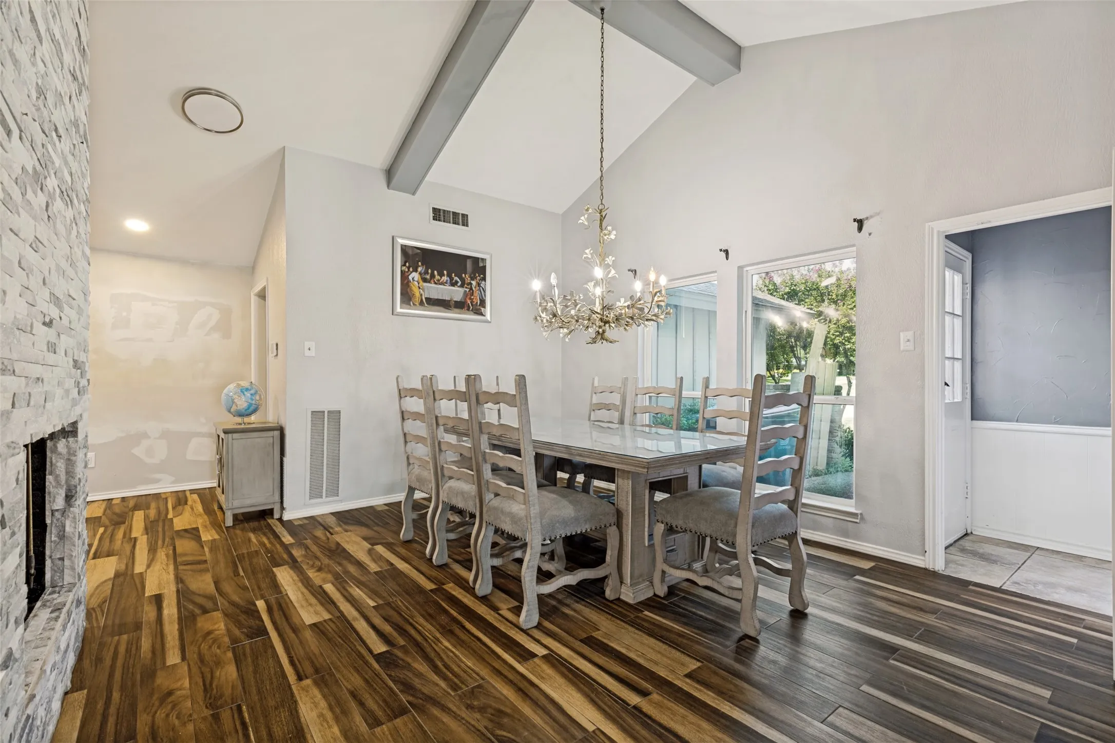 Dining area with vaulted ceiling and exposed beams