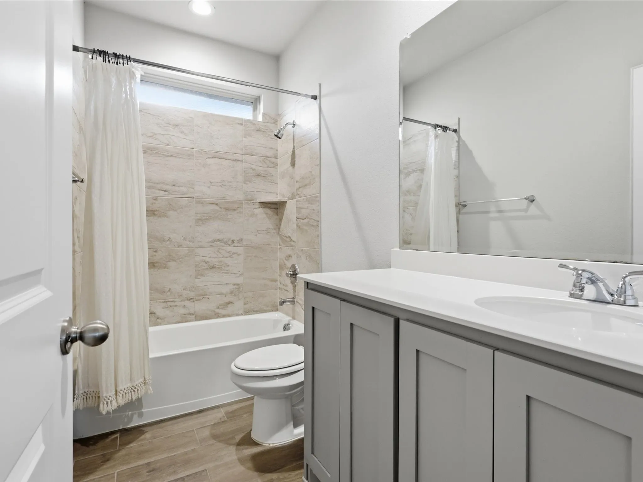 Modern bathroom with light wood-finish flooring