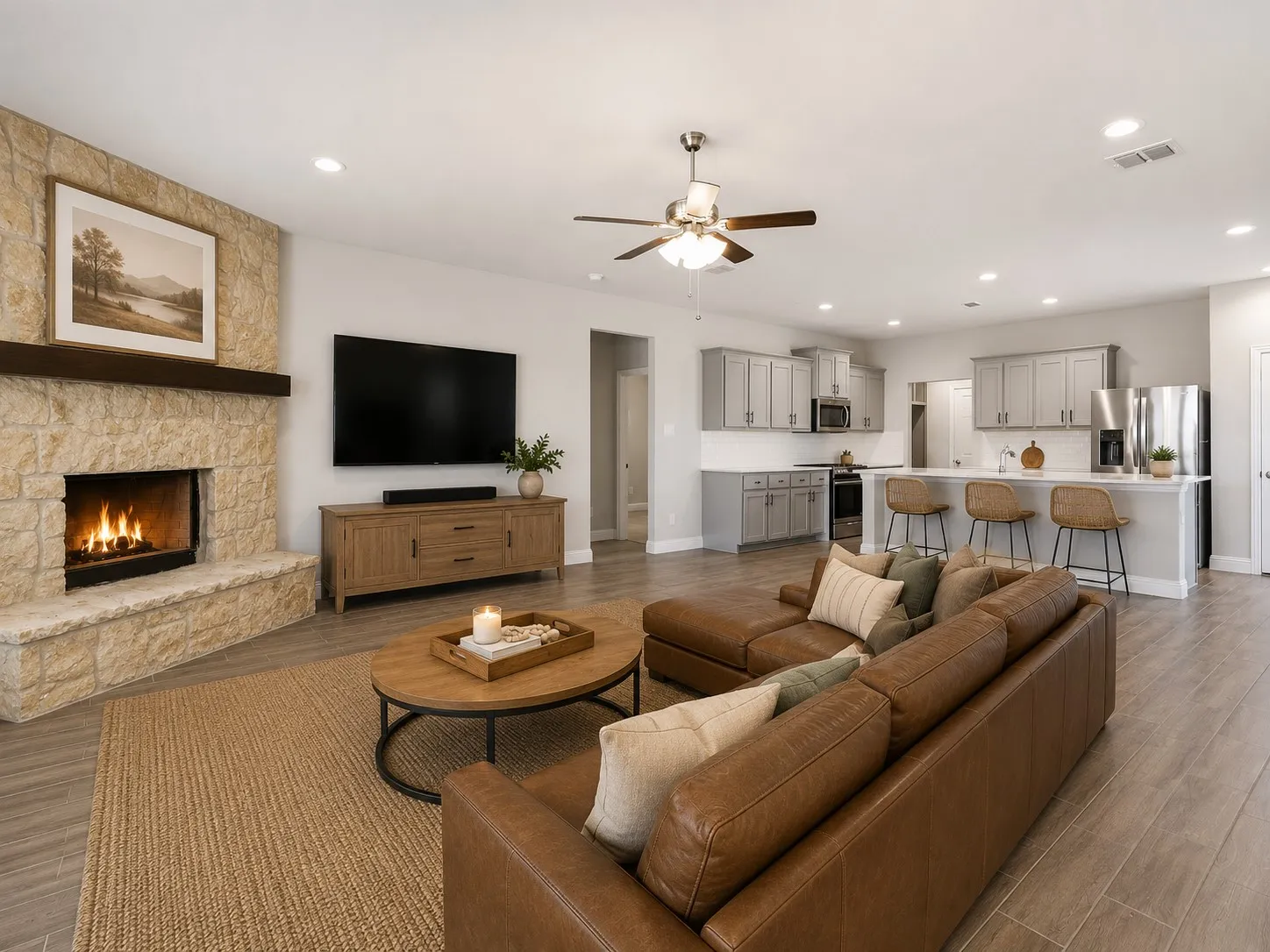 Spacious open-concept interior featuring light wood-finish flooring