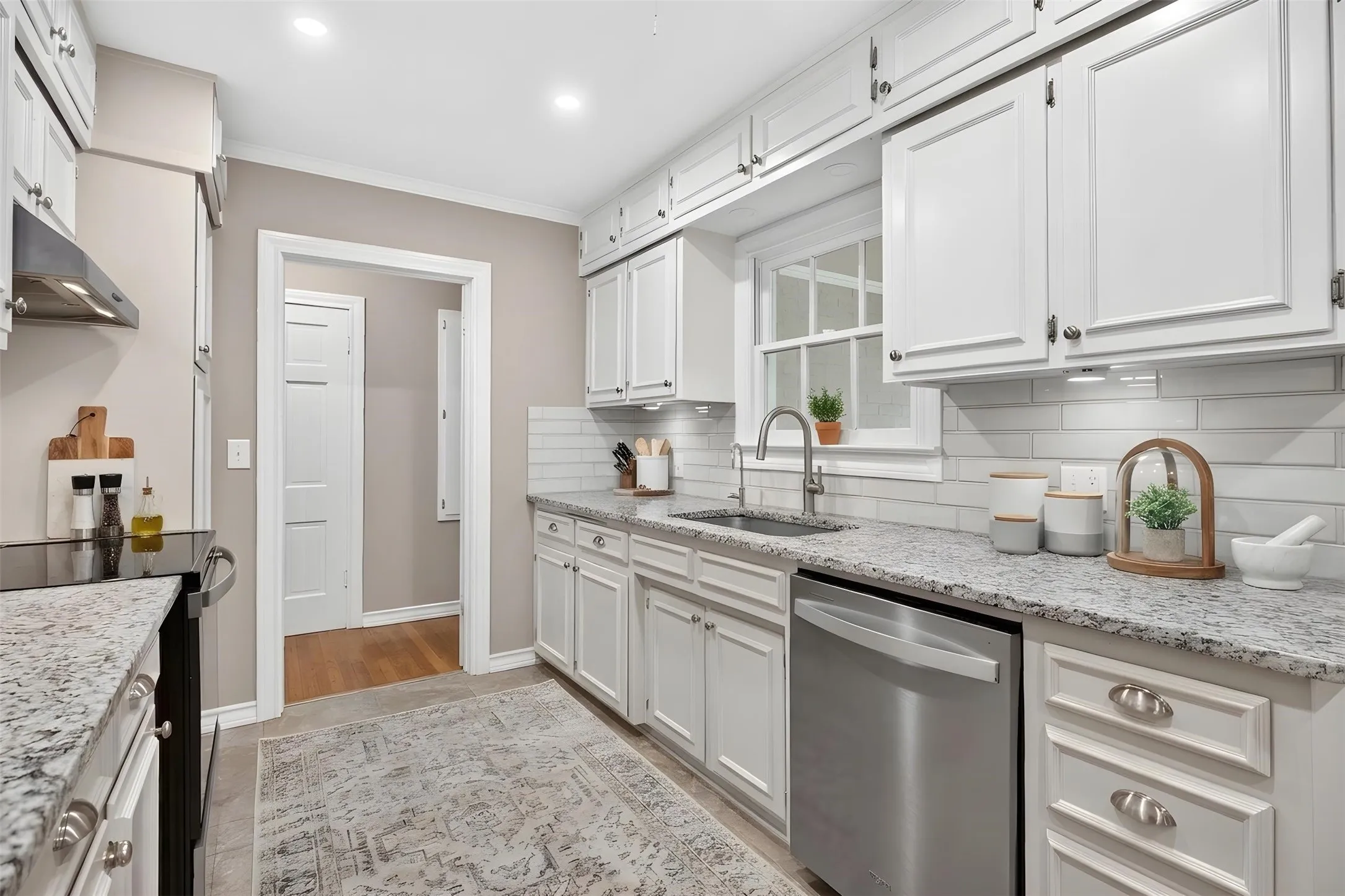 Virtually Staged: New counters, appliances, backsplash, hardware, sink and faucet. All tasteful and complimentary of the home.