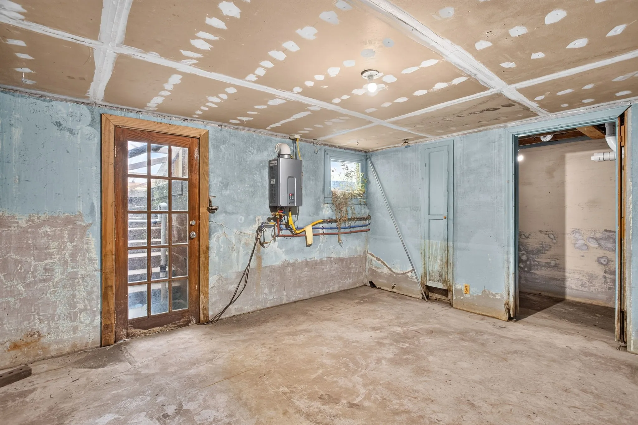 And y'all - how unique is this feature?! A basement with so many potential uses - the built-in ironing board and French door are treasures from another time.