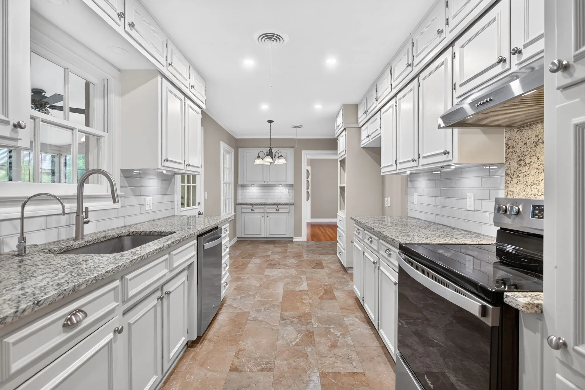 How pretty is this galley kitchen? Luxury Vinyl Tile makes for better performing floors in this part of the home.