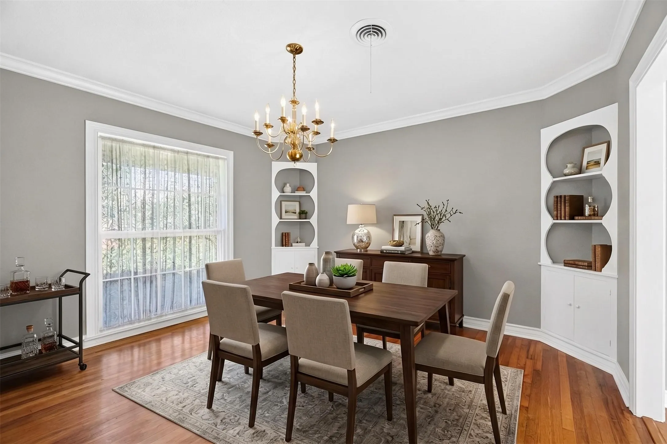 Virtually Staged: the dining room is washed with natural light and anchored by original corner built-ins. We love the chandelier that echoes days of dressing for dinner.