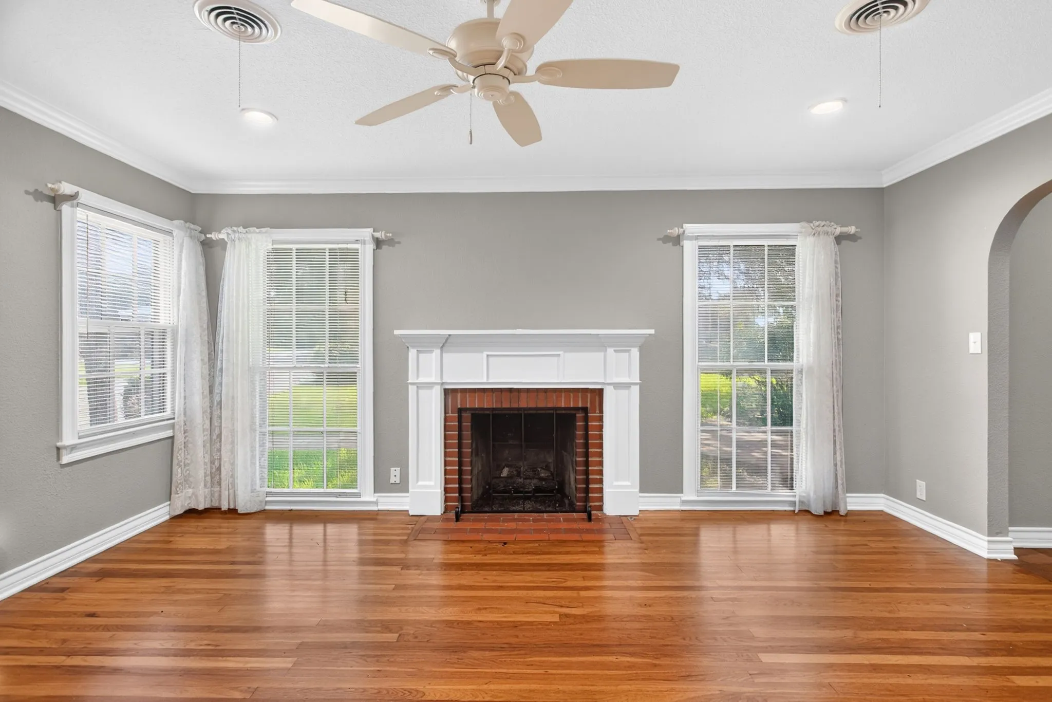 Windows flank the fireplace with views to the large front yard.