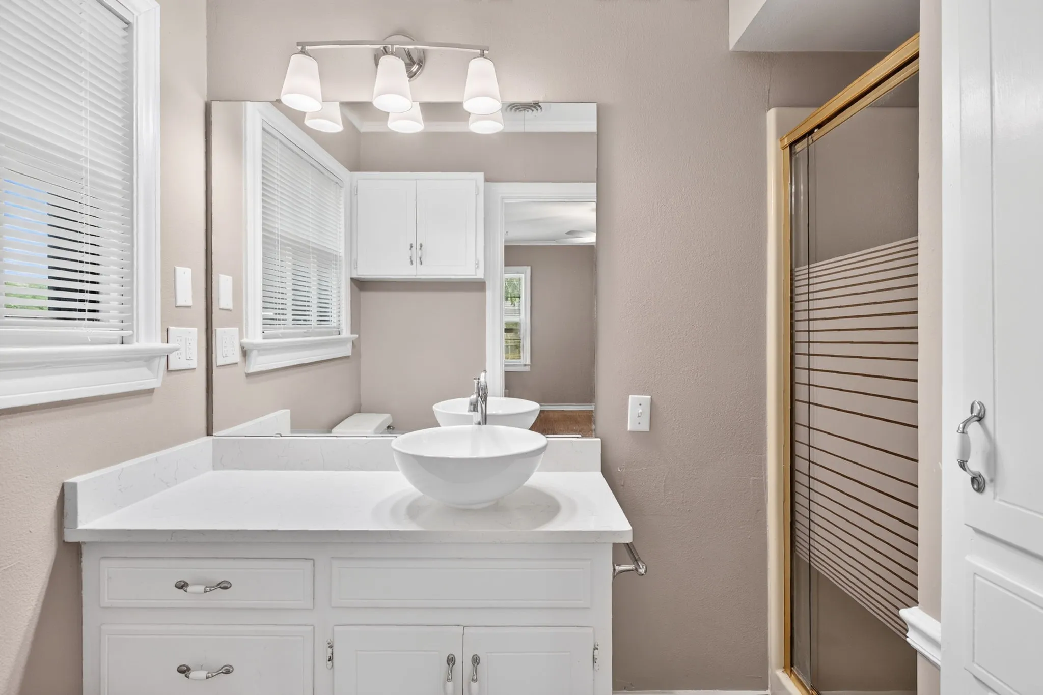 More thoughtful improvements in this bathroom - the sink, counter, mirror and lighting are all considerate of the original charm of the home.