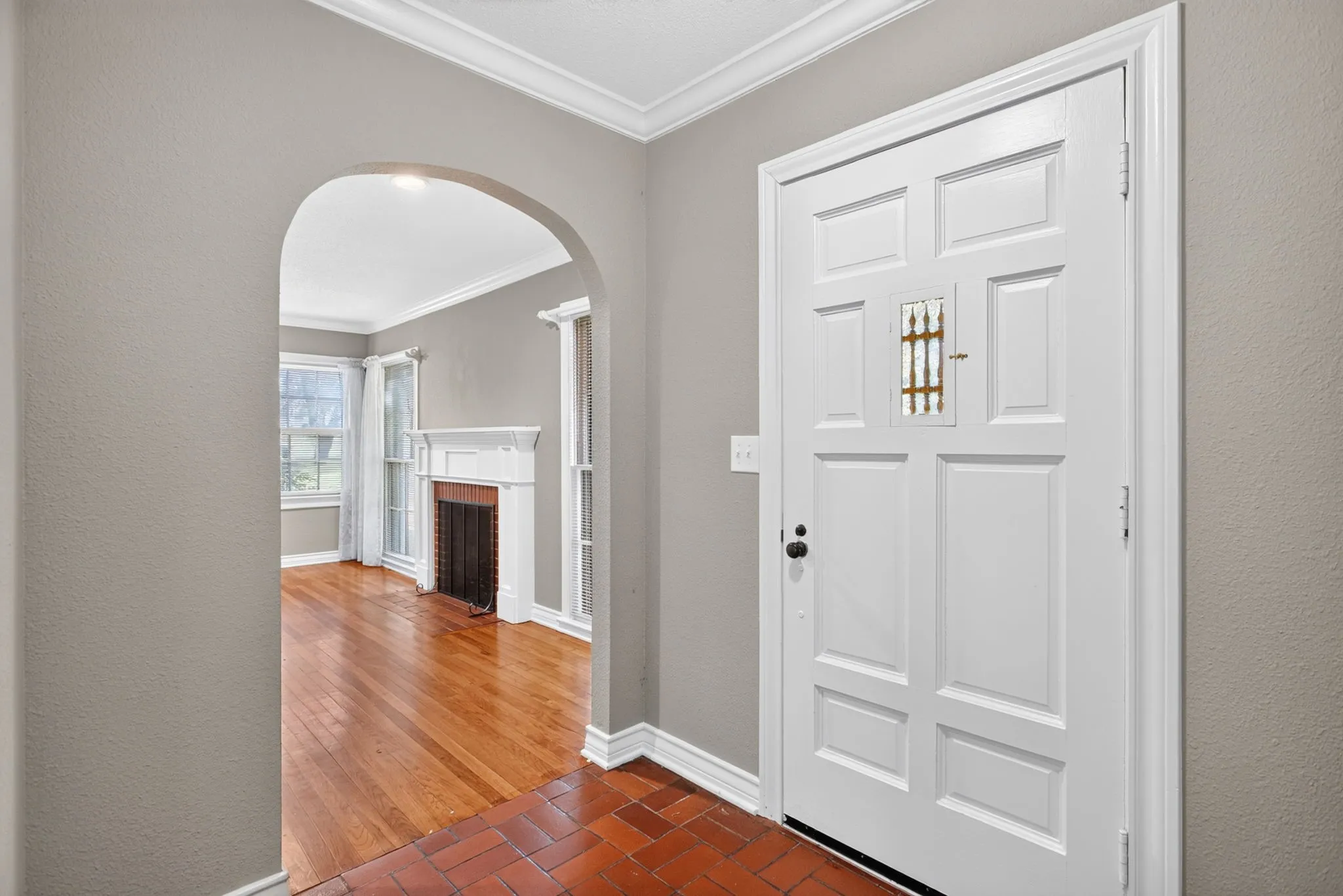 Already breaking hearts with this foyer featuring the original brick pavers and a peek into the front living room.