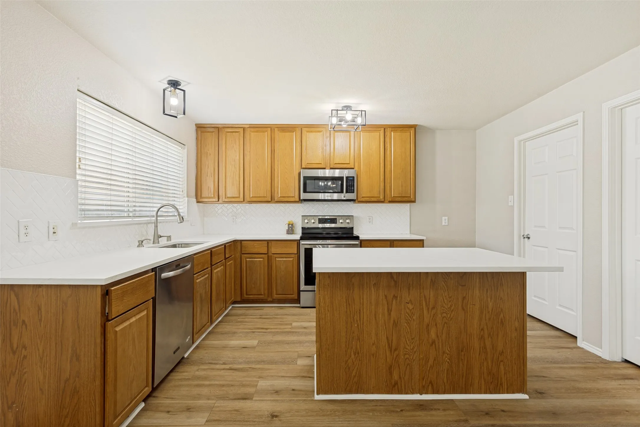 Well-appointed kitchen featuring wood-finish cabinetry and a central island