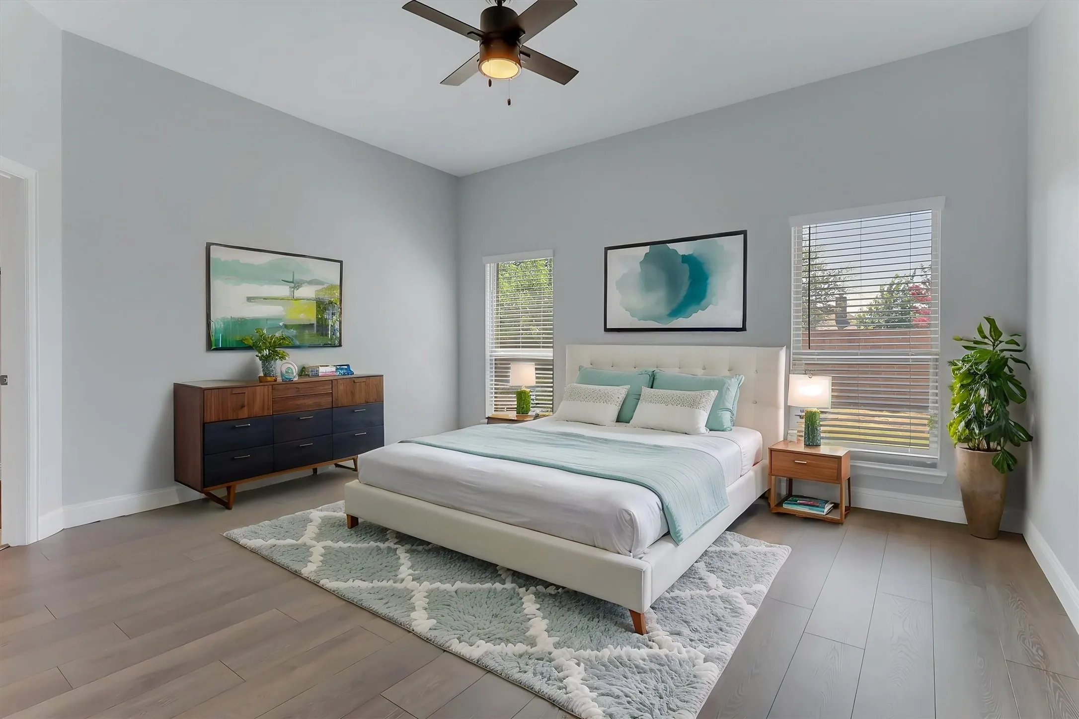 Bedroom featuring high ceilings, wood-finish flooring, and multiple windows with blinds. Virtual staged