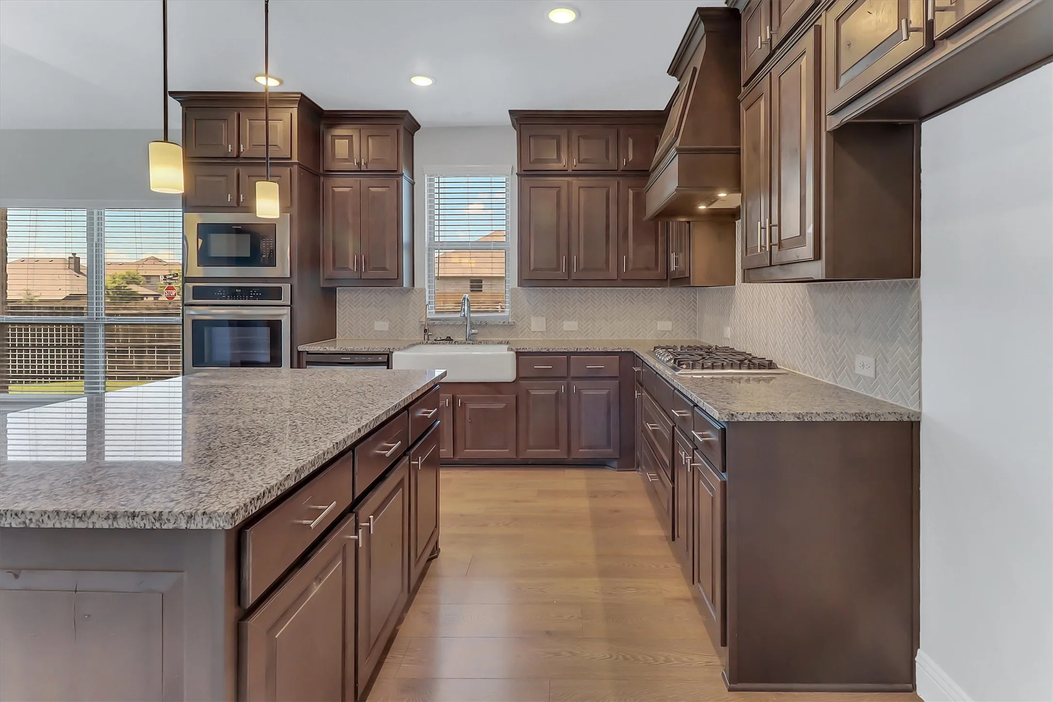 Kitchen with a central island featuring a granite-finish countertop
