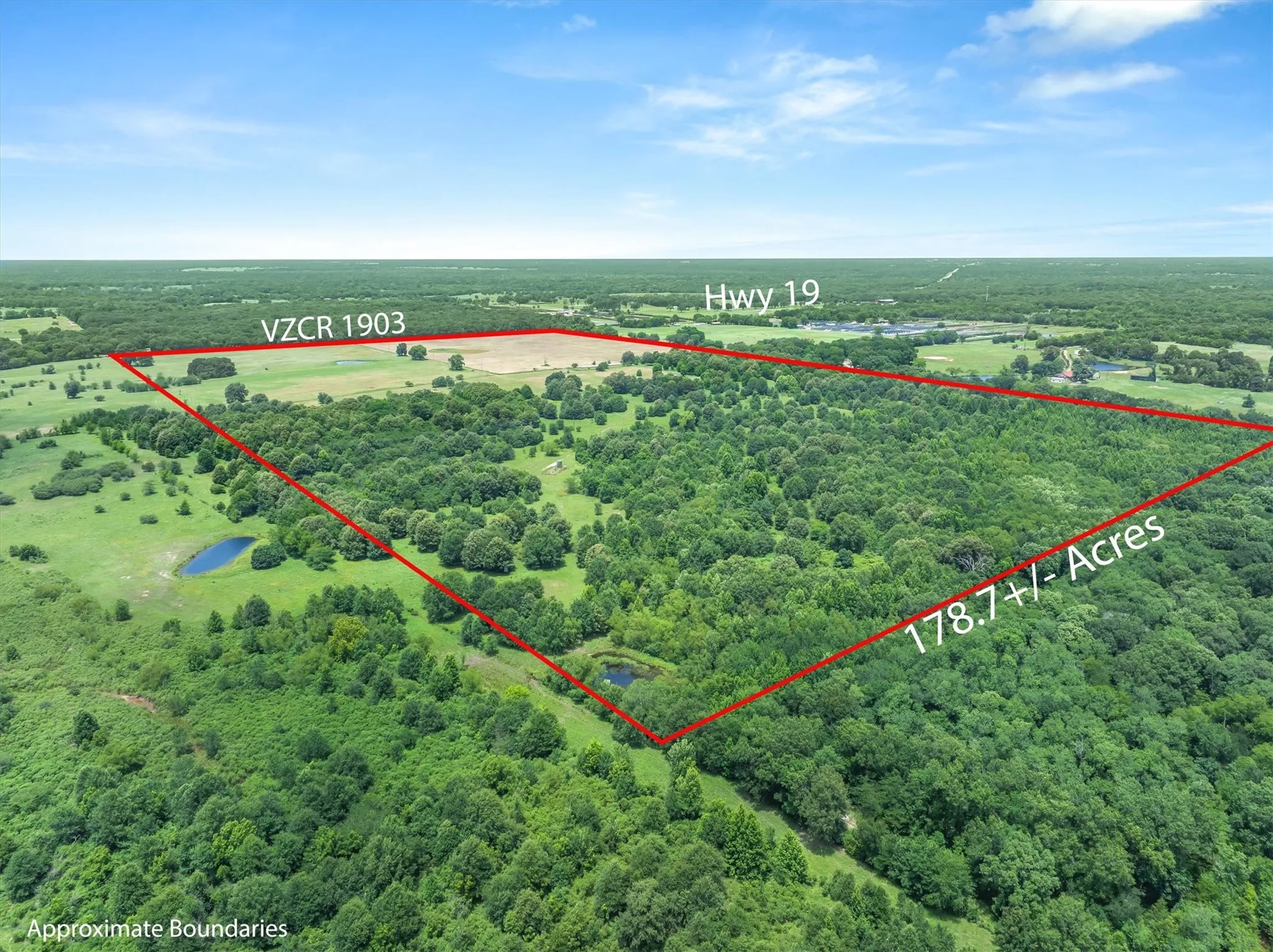 Expansive 178.7+/- acre property featuring diverse topography with wooded areas and open fields