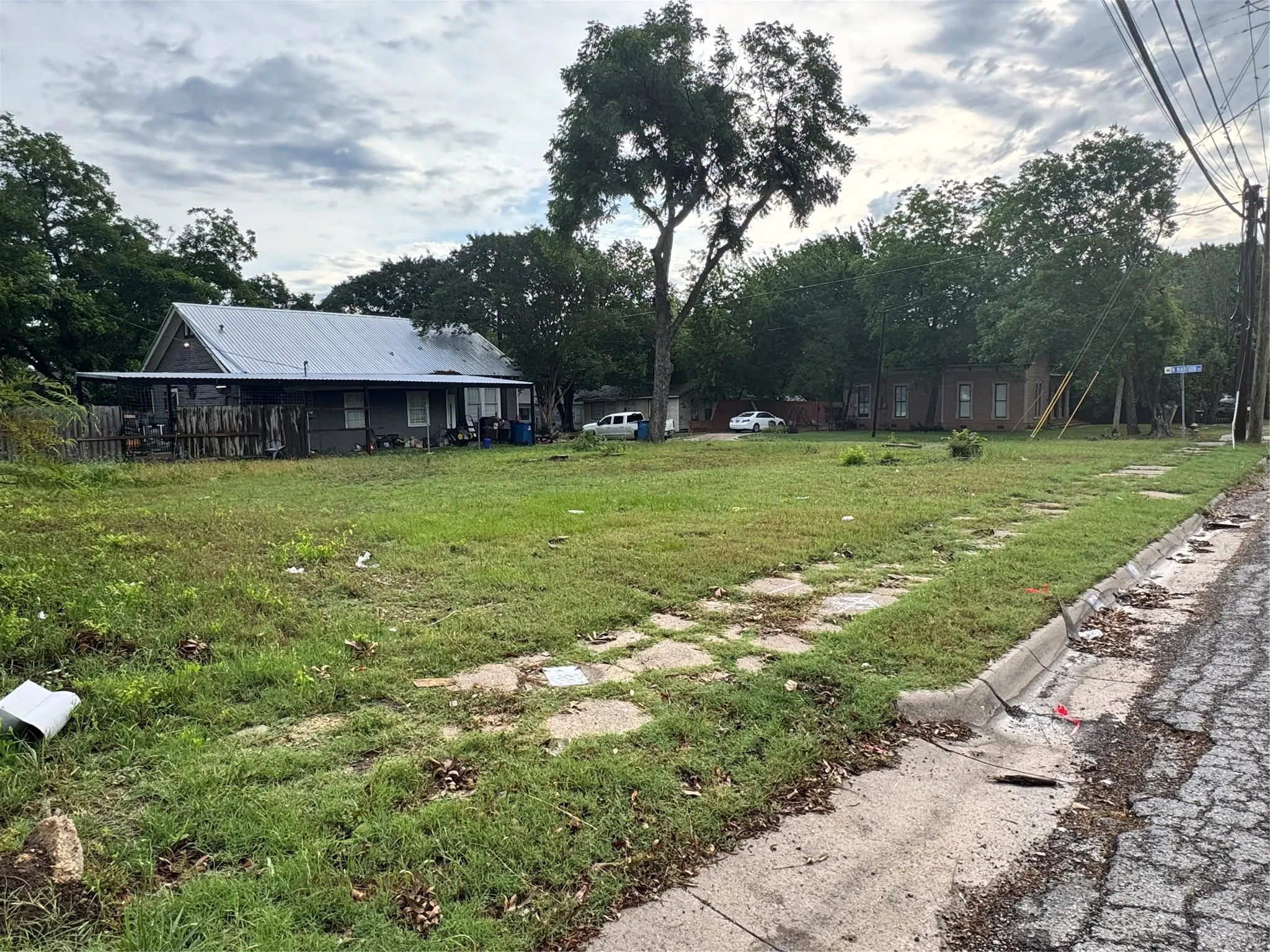 Expansive lot featuring mature trees and a substantial grassy area
