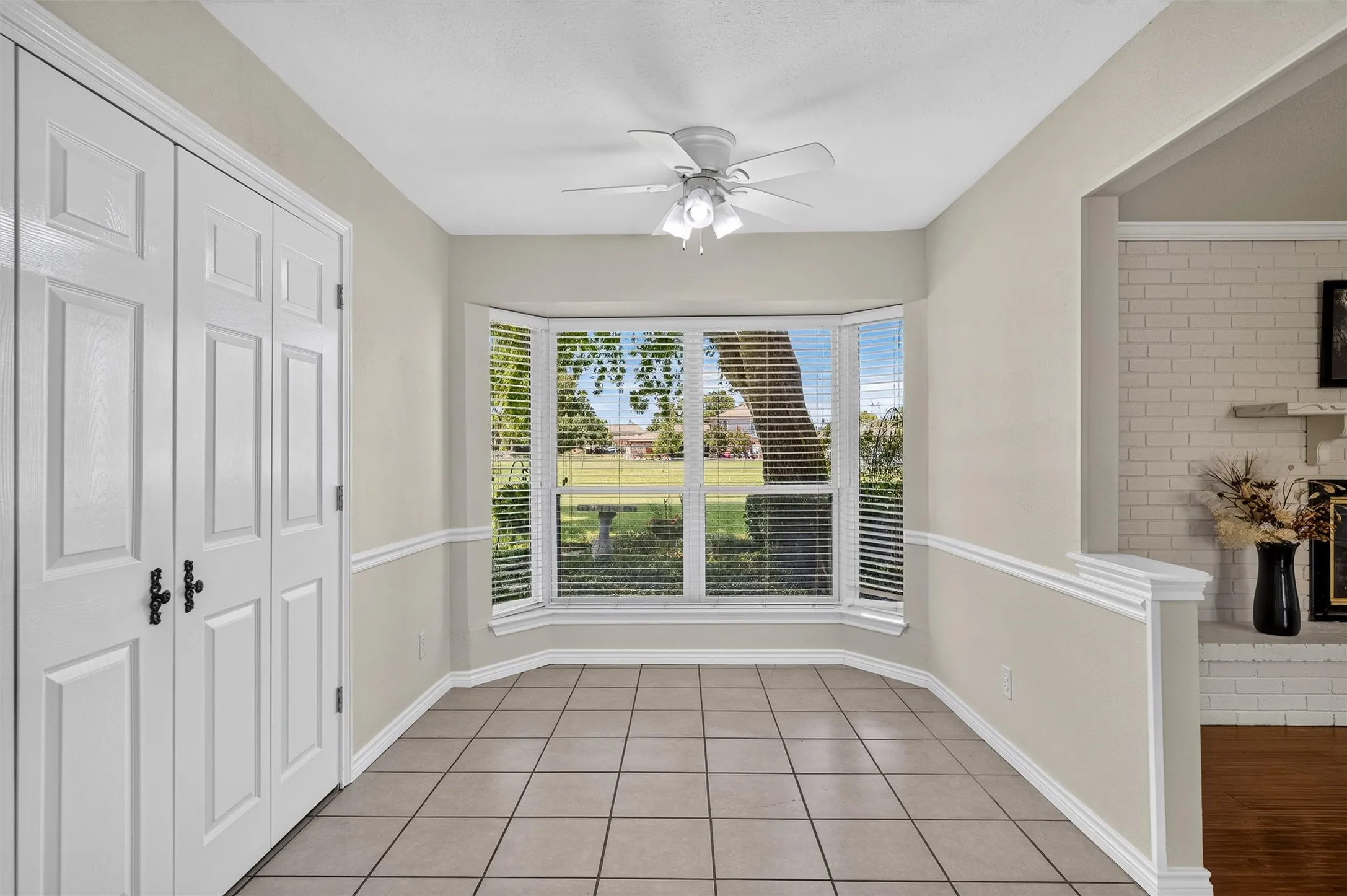 Breakfast area with double doors opening to spacious walk in pantry
