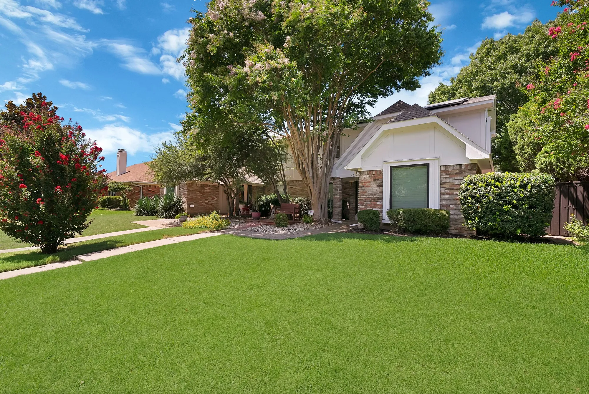 Expansive front lawn with a concrete walkway
