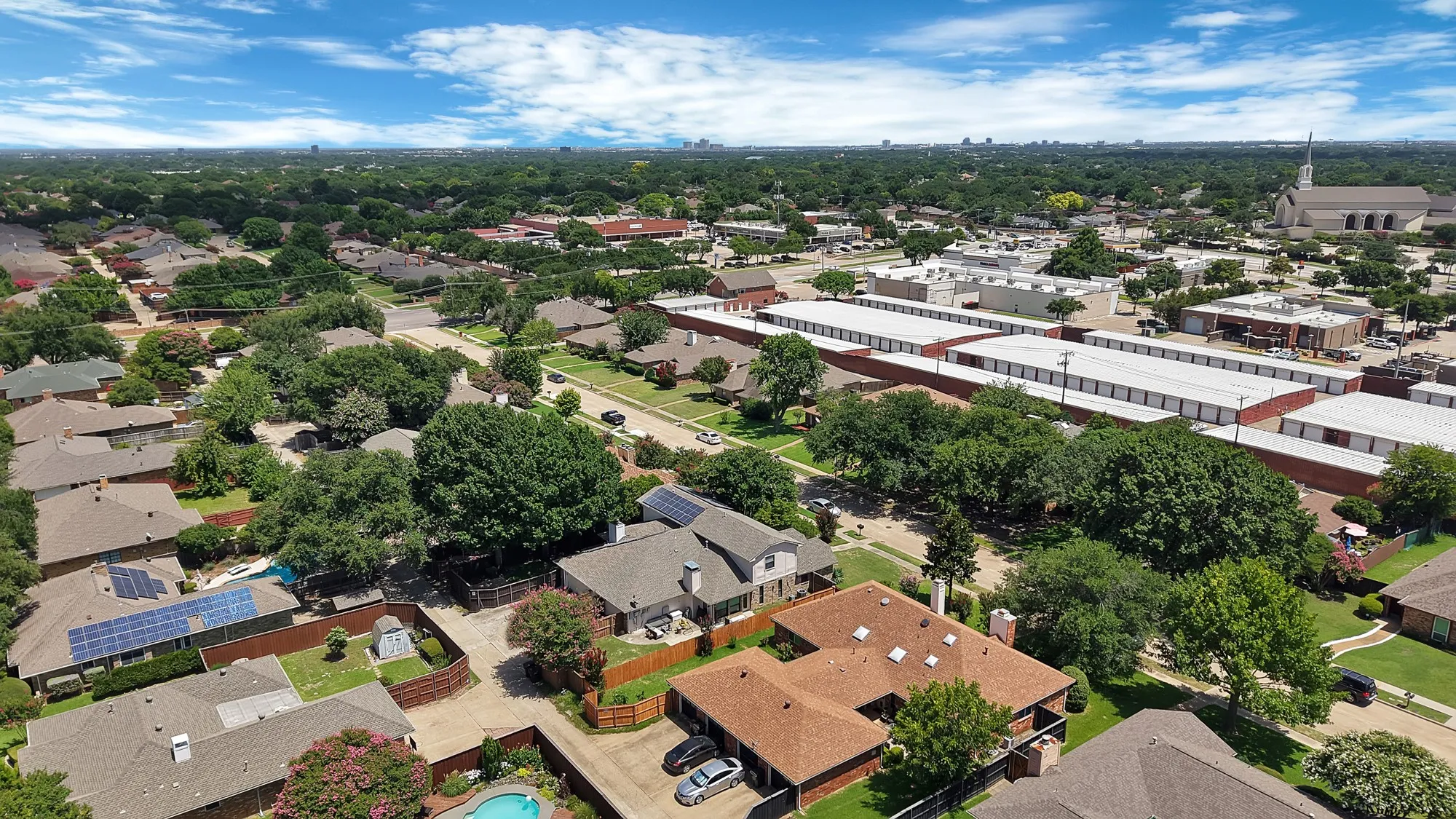 Aerial perspective showcasing a residential area with mature tree coverage