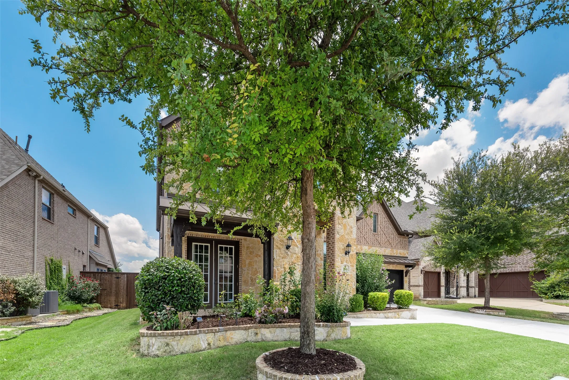 Stone and brick facade residence with dark trim accents
