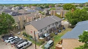 Aerial perspective showcasing multiple two-story townhome structures with brick and siding exteriors