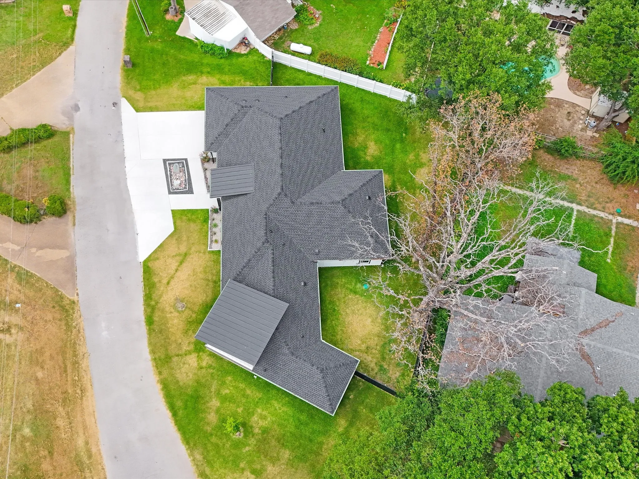 Contemporary roofline featuring dark shingles and a metal roof accent
