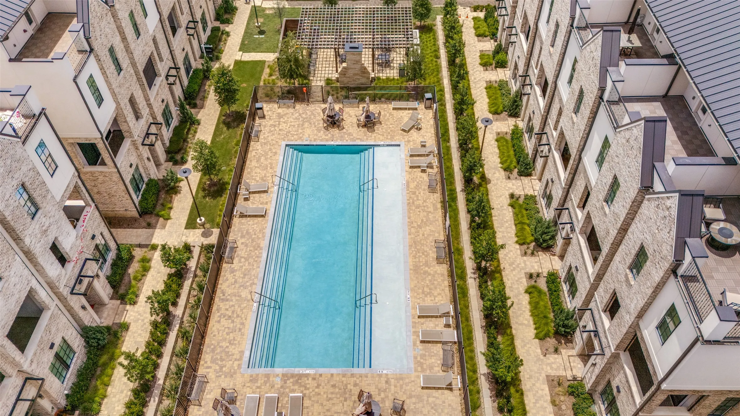 Rectangular swimming pool with integrated steps surrounded by a paver patio
