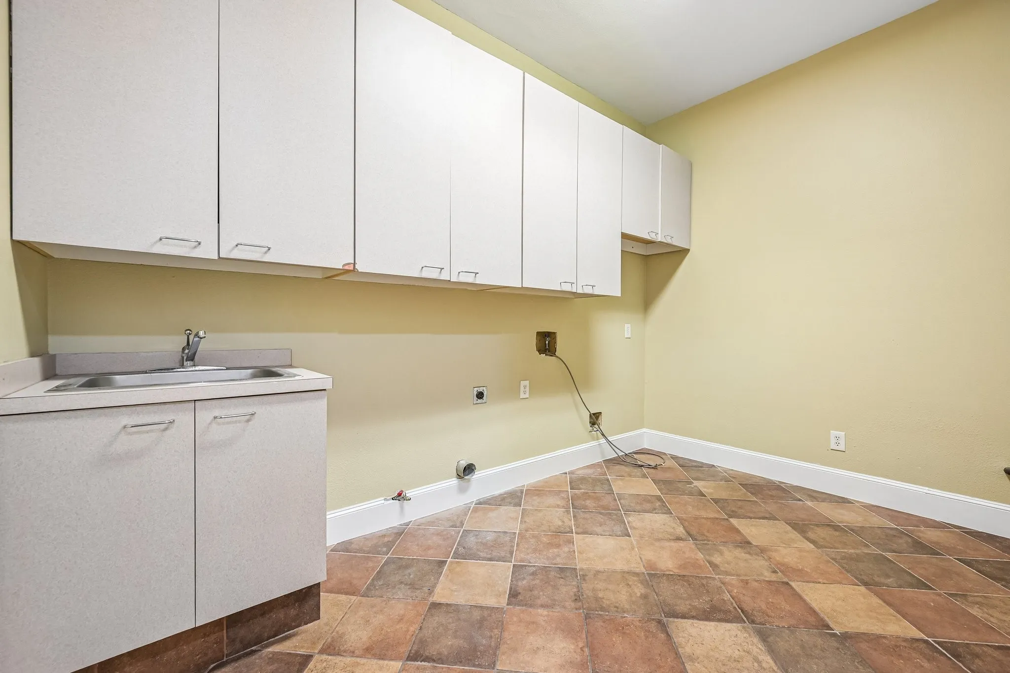 Cabinets, sink, shelving, and room for a freezer