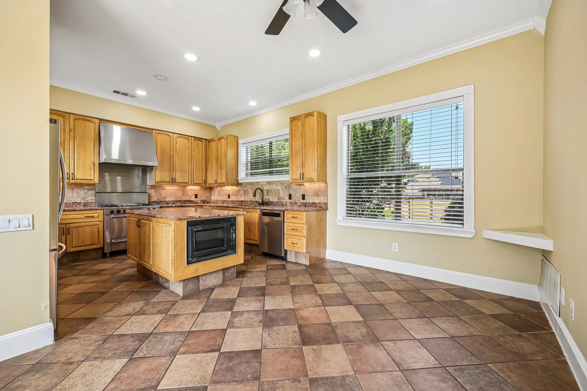 Well-appointed chef's kitchen with granite counters, generous cabinet space, and breakfast area