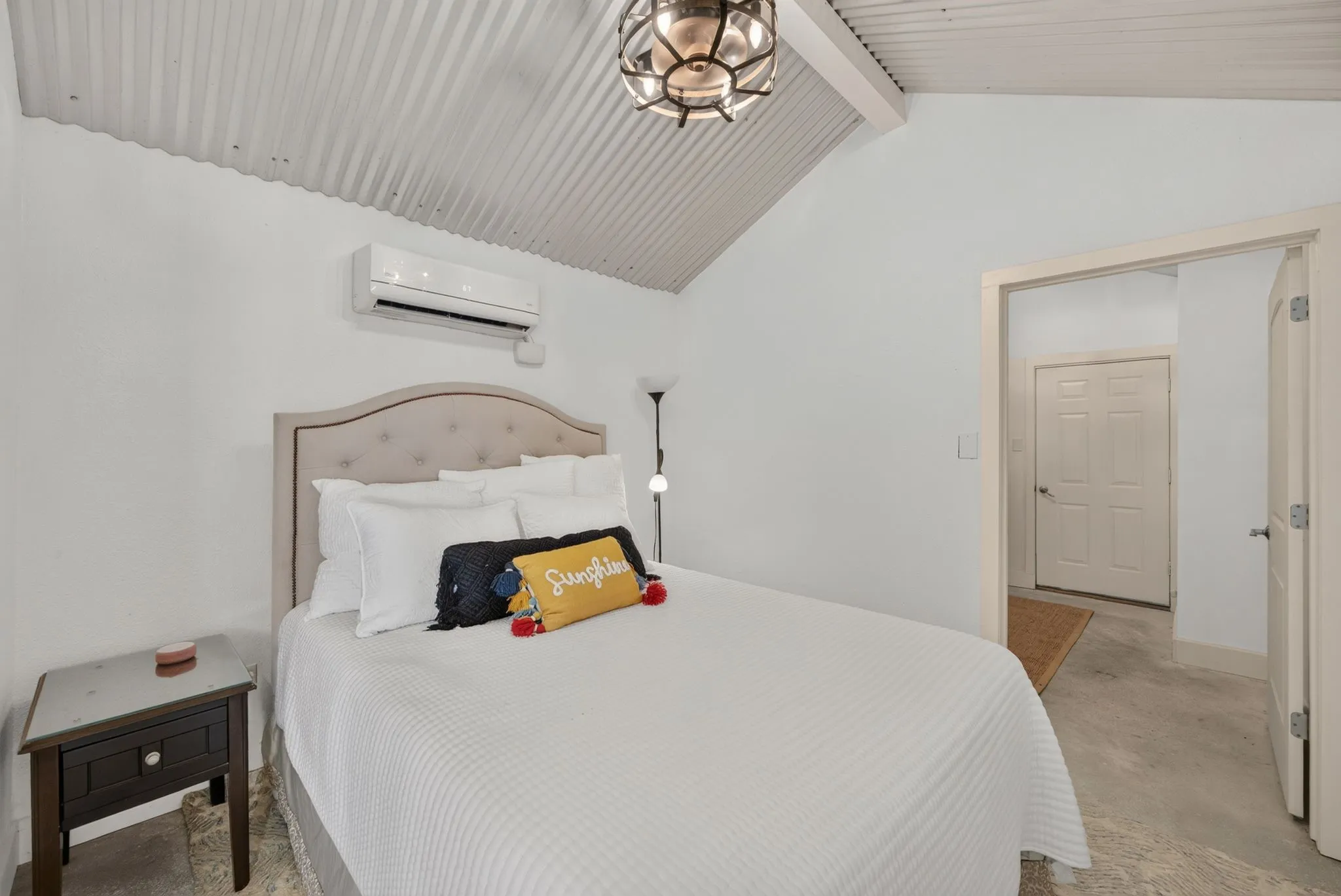 Vaulted corrugated metal ceiling paired with white walls