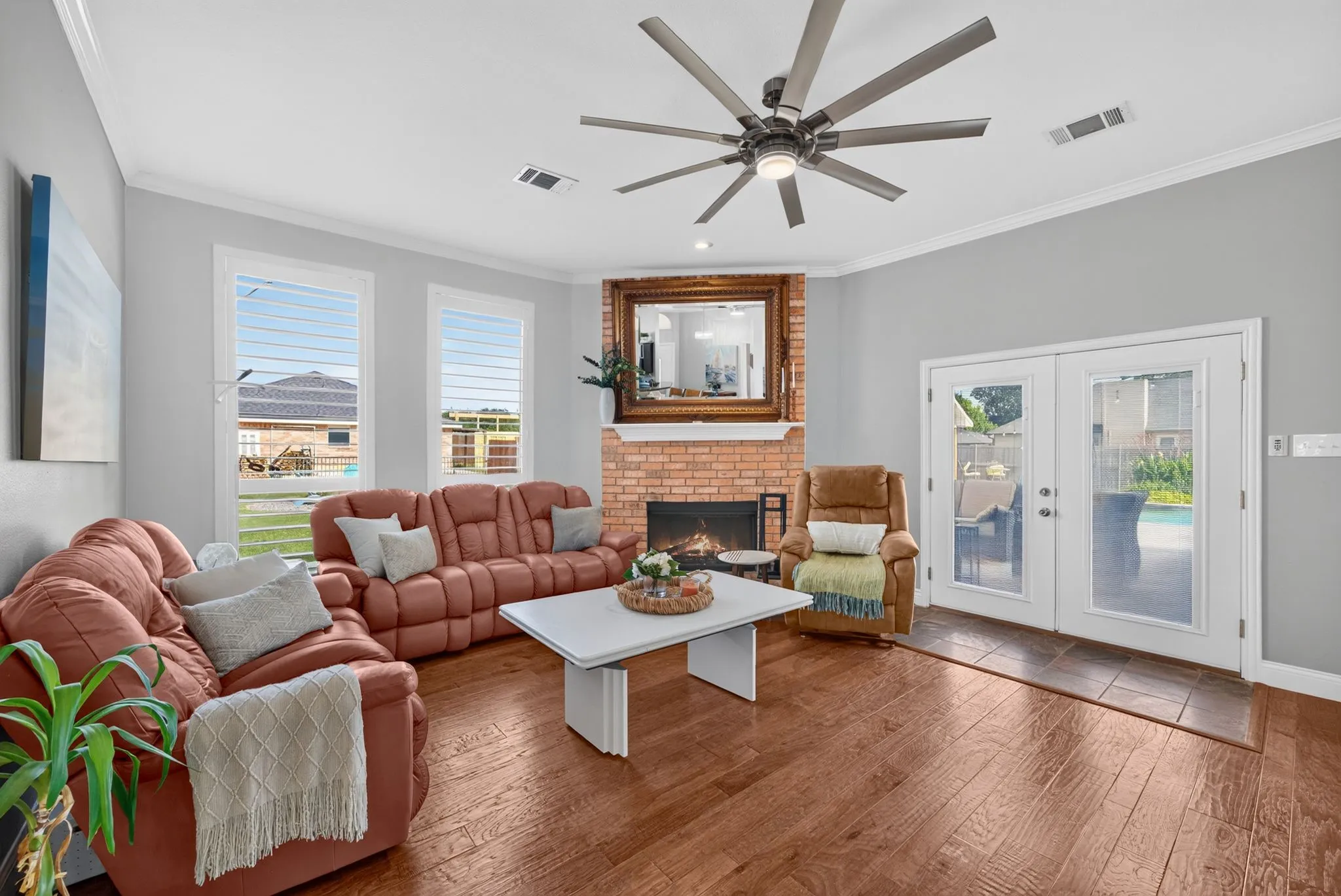 Living area featuring wood-finish flooring and a brick fireplace